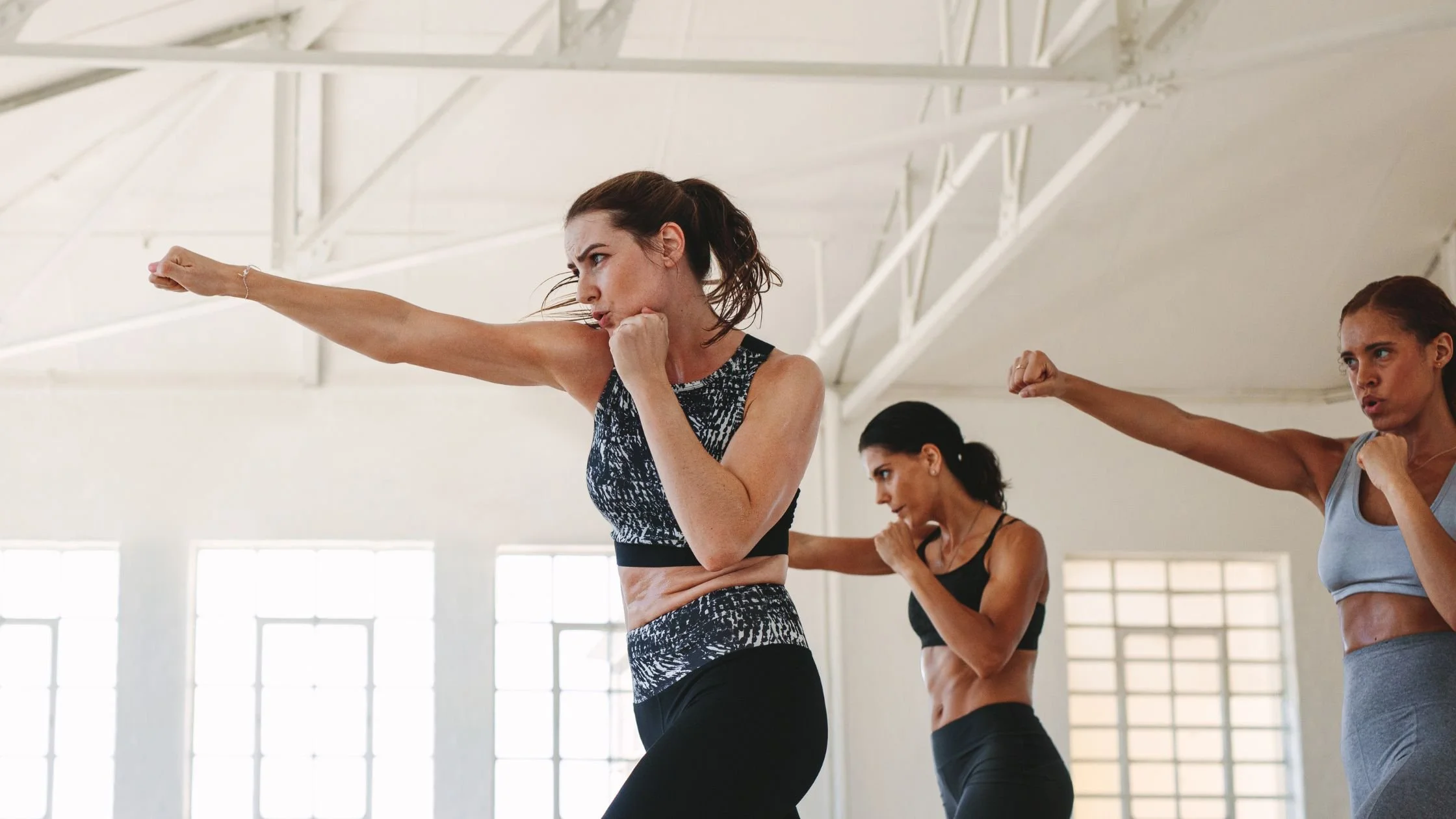 Women training with focus and determination, symbolising confidence and courage during career change