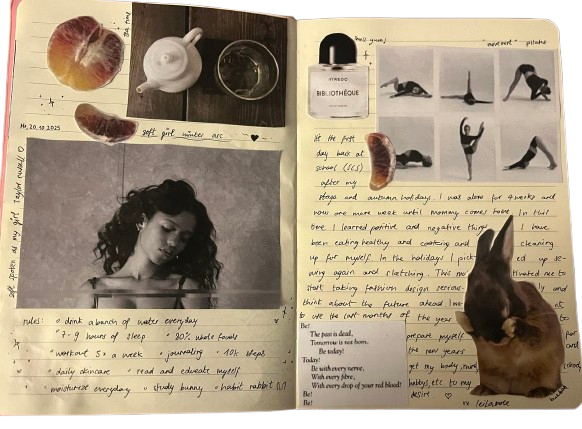Open journal with black and white photographs, handwritten notes, and small objects including a white teapot, a glass, and a food item. A black-and-white photo of a woman, a polaroid picture of a cat, and various images of exercising individuals are visible.
