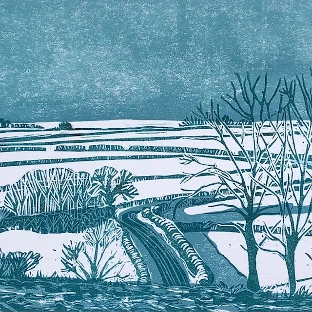 An illustrated landscape of snow-covered fields, a winding road, leafless trees, and bushes, with a misty sky in the background.