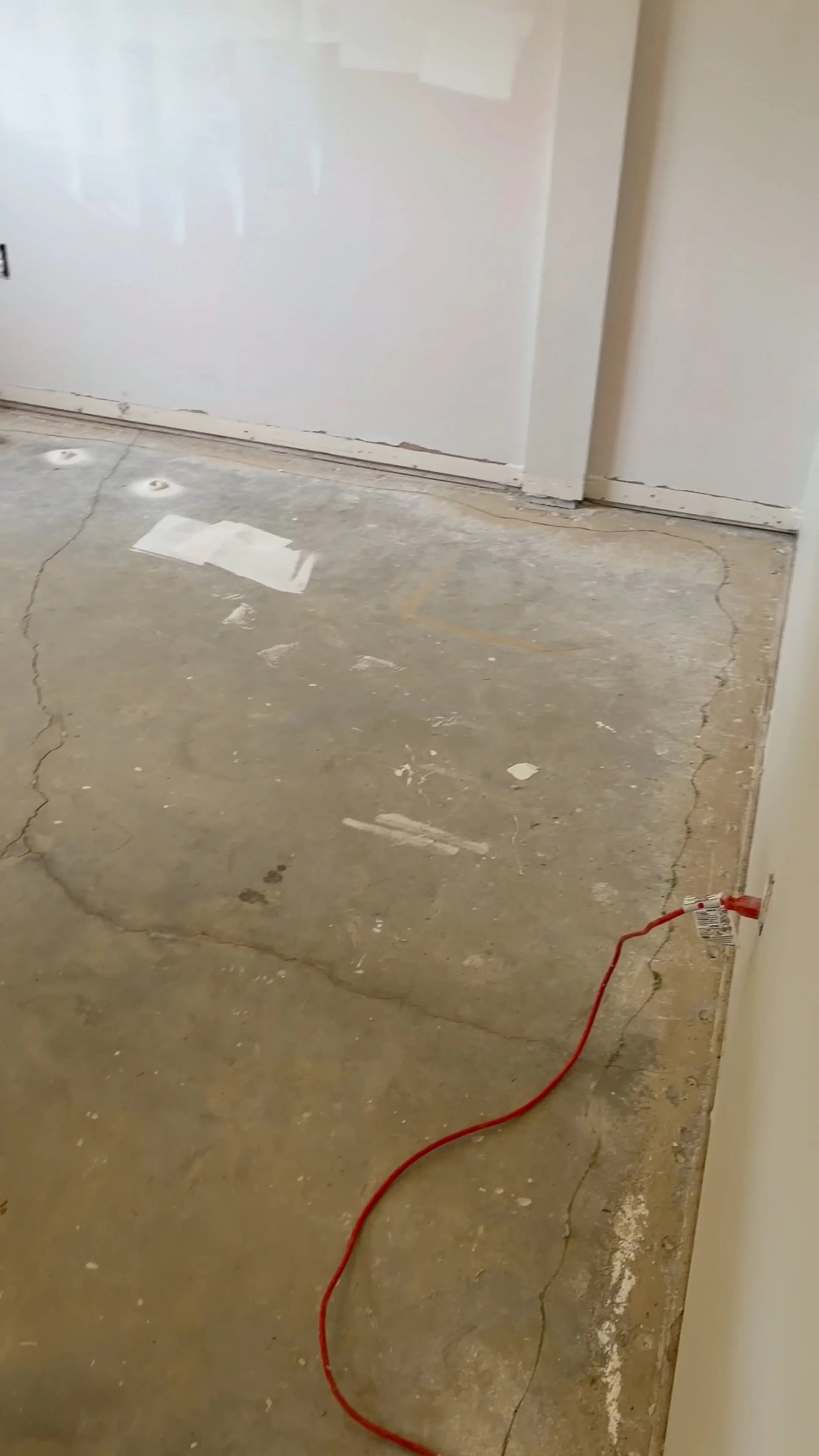 Guest house bedroom with worn flooring and wall damage before renovation in Dade City