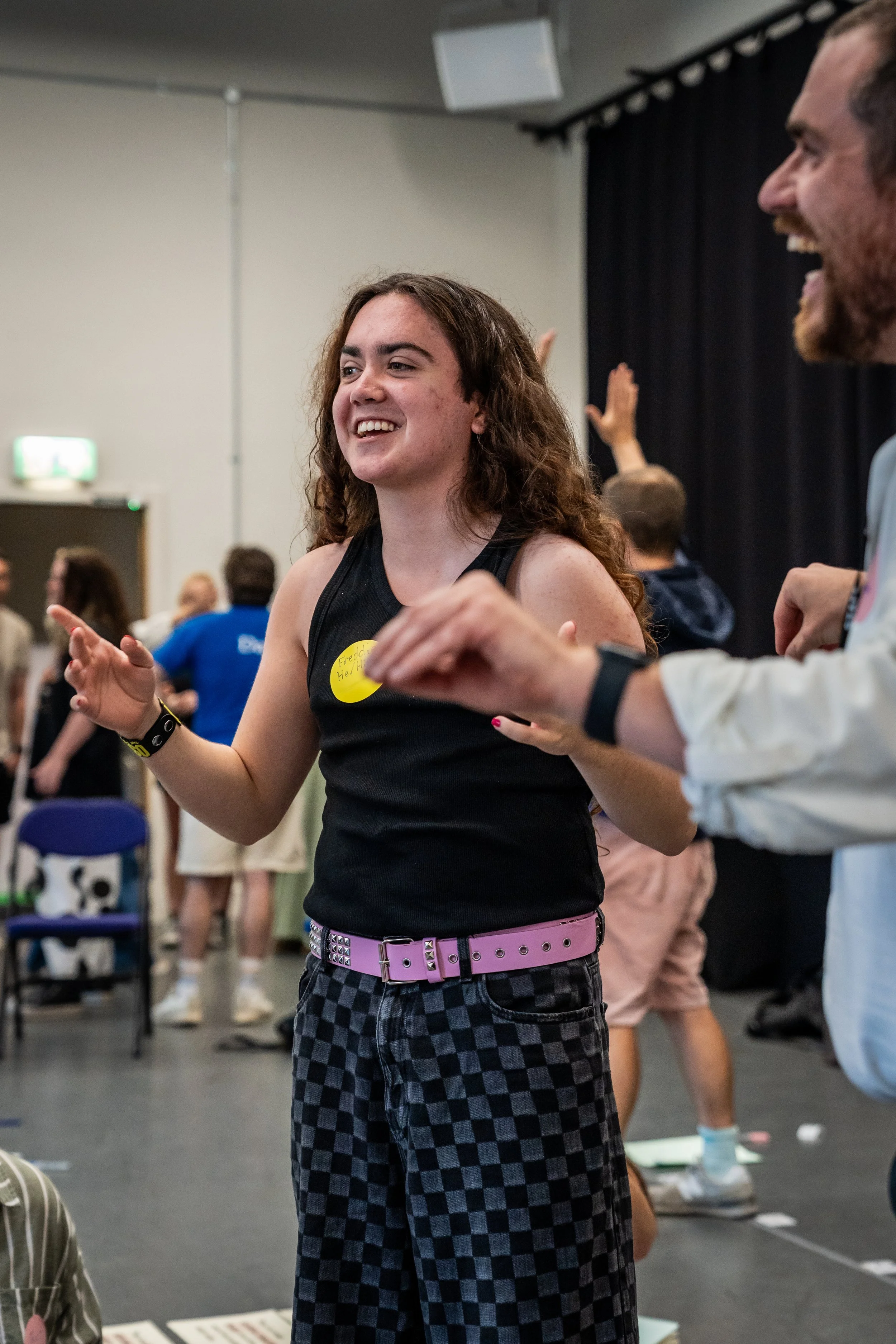 A young person standing and taking part in a group game.