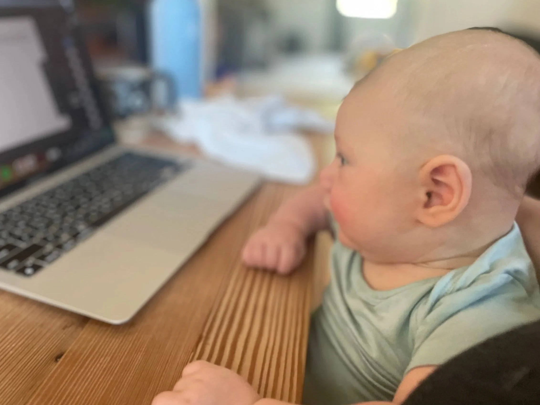 baby sitting at computer