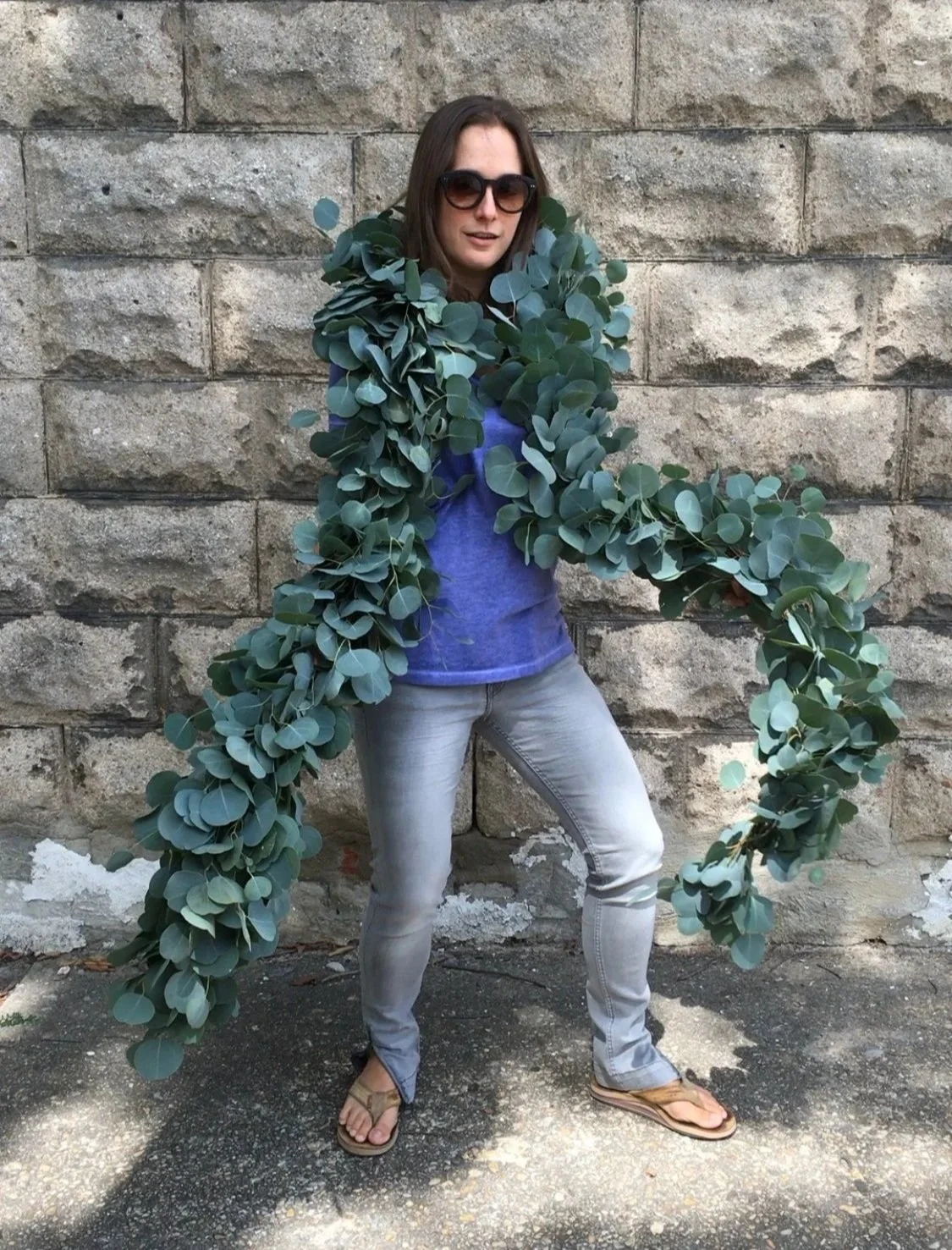 woman with long garland of eucalyptus around her