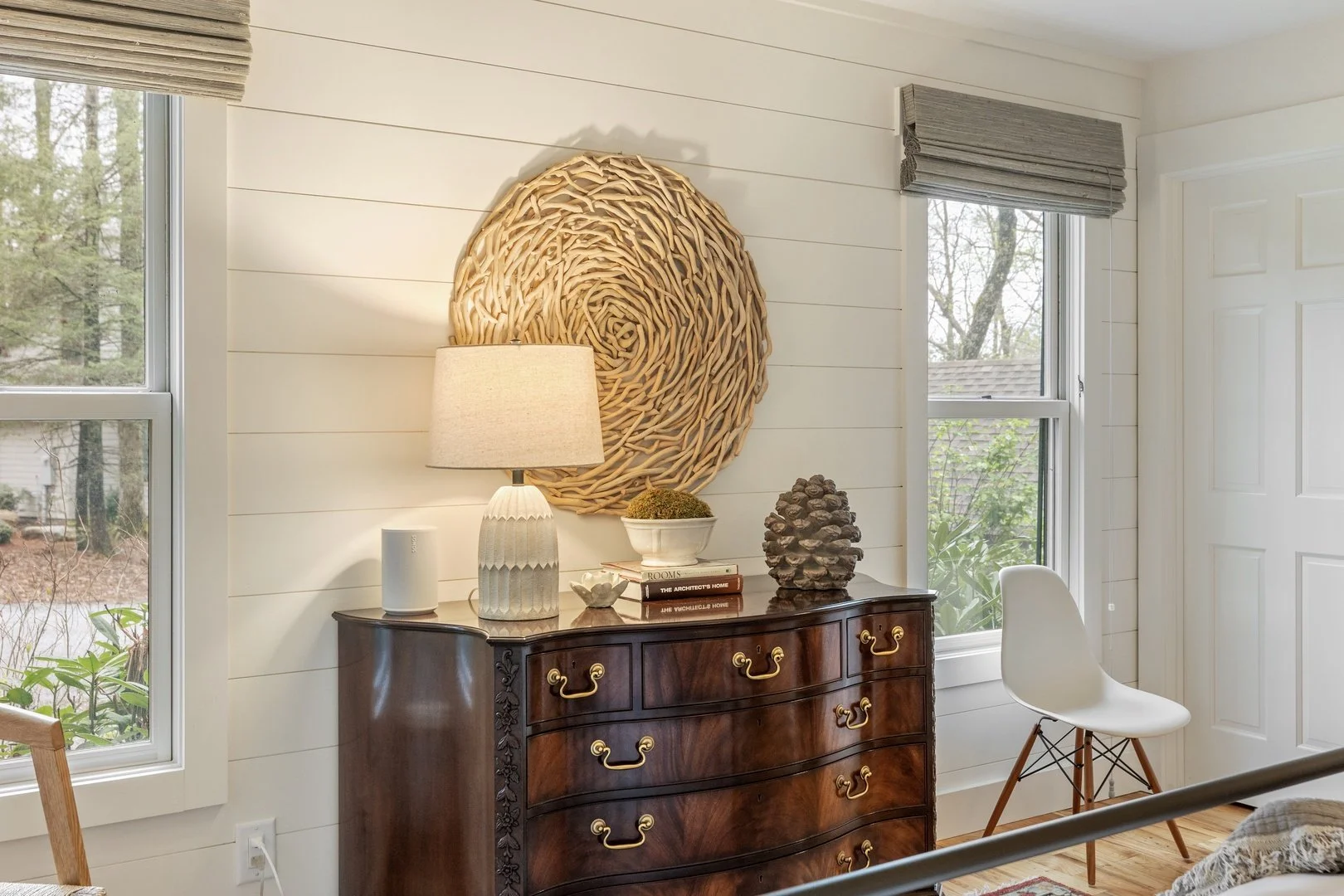 Antique furnishings and a gilded mirror in a Creekwood Cottage bedroom.