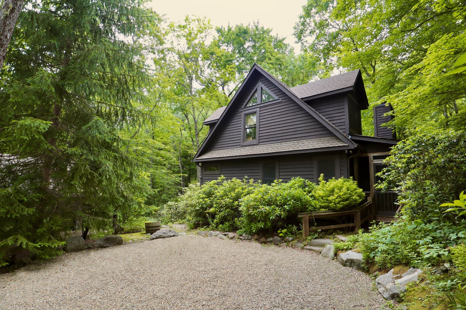 Creekwood Cottage nestled among trees in Highlands, North Carolina.