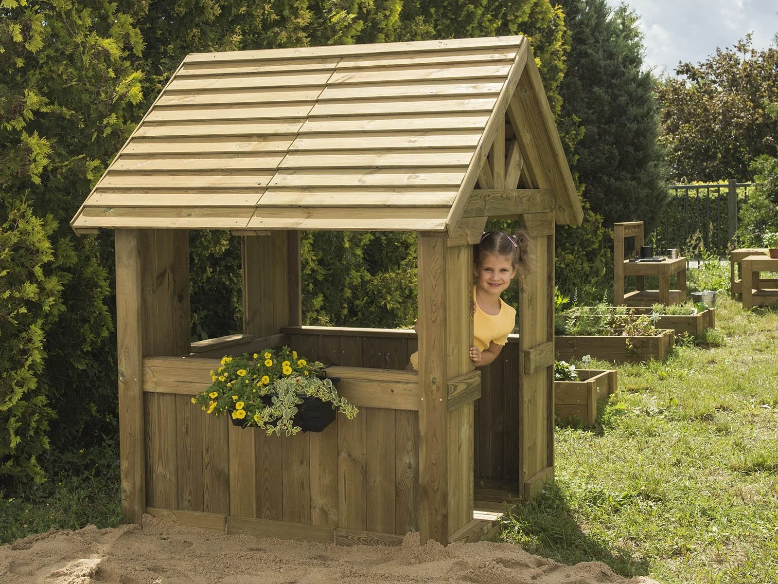 Natural wooden playhouse made of impregnated pine wood, designed for children aged 1–5 to support imaginative and outdoor sensory play.