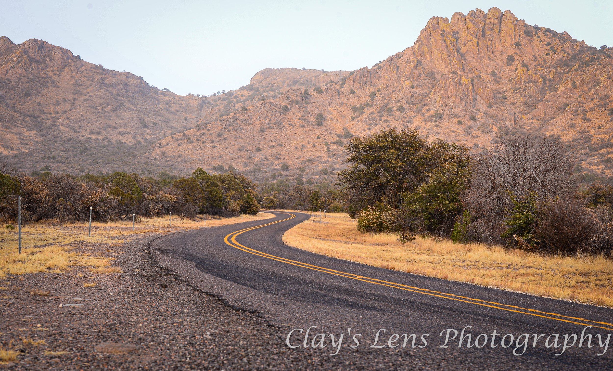 Golden Sunset Over Winding Road in the Davis Mountains – West Texas by Clay's Lens