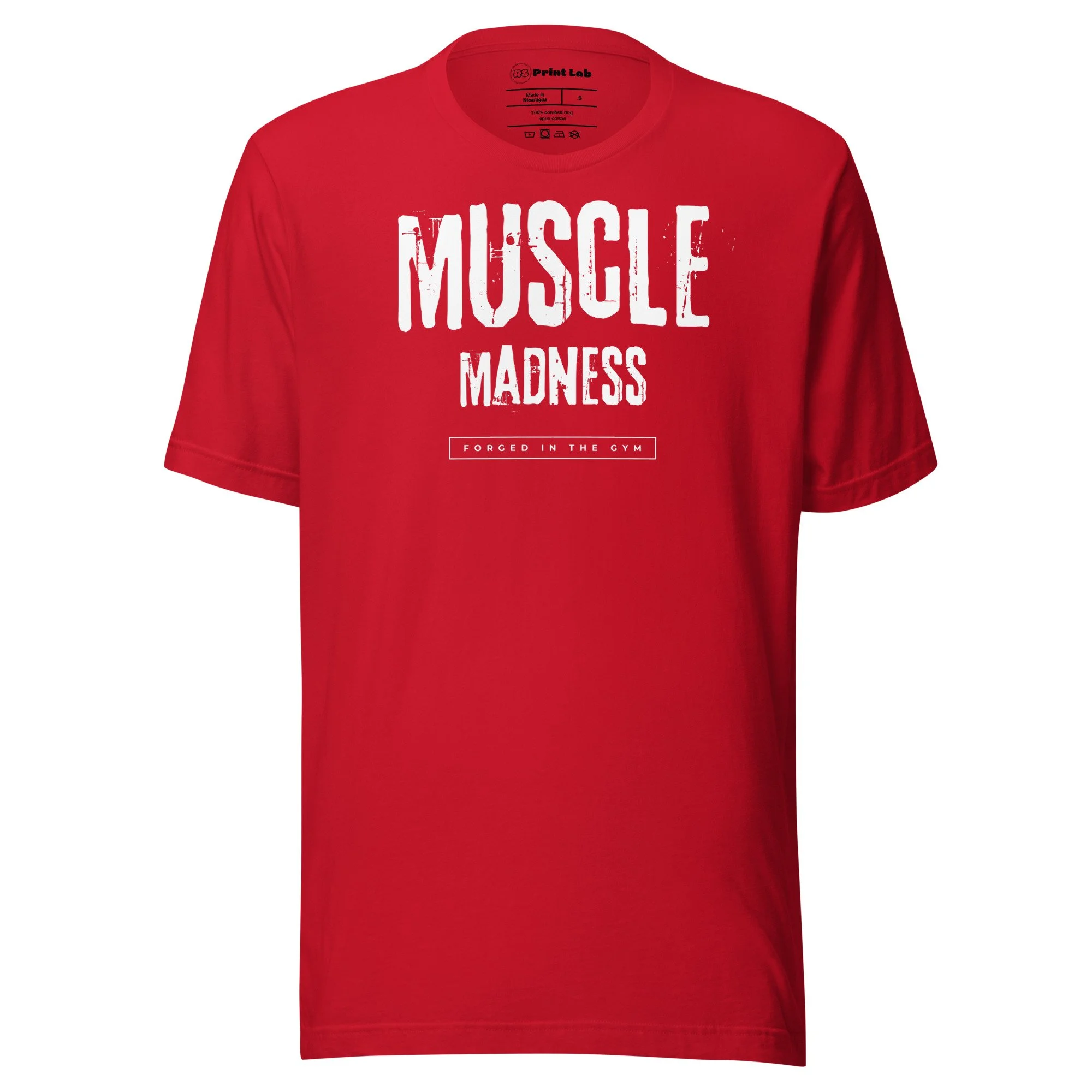 A red T-shirt with the words 'MUSCLE MADNESS' printed in large white letters on the front and the phrase 'FORGED IN THE GYM' written underneath in a rectangular box.
