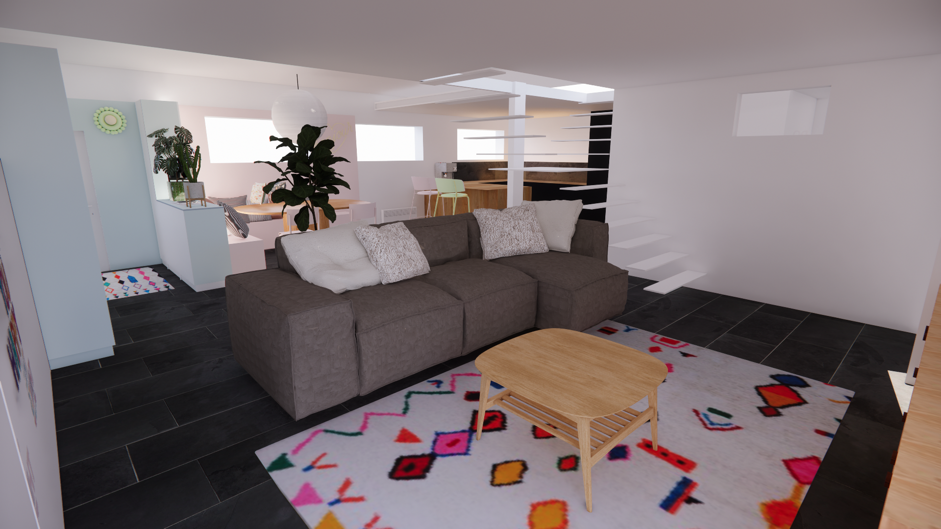 Salon avec canapé gris, tapis coloré, table en bois, escalier blanc, fond avec coin repas et cuisine.
