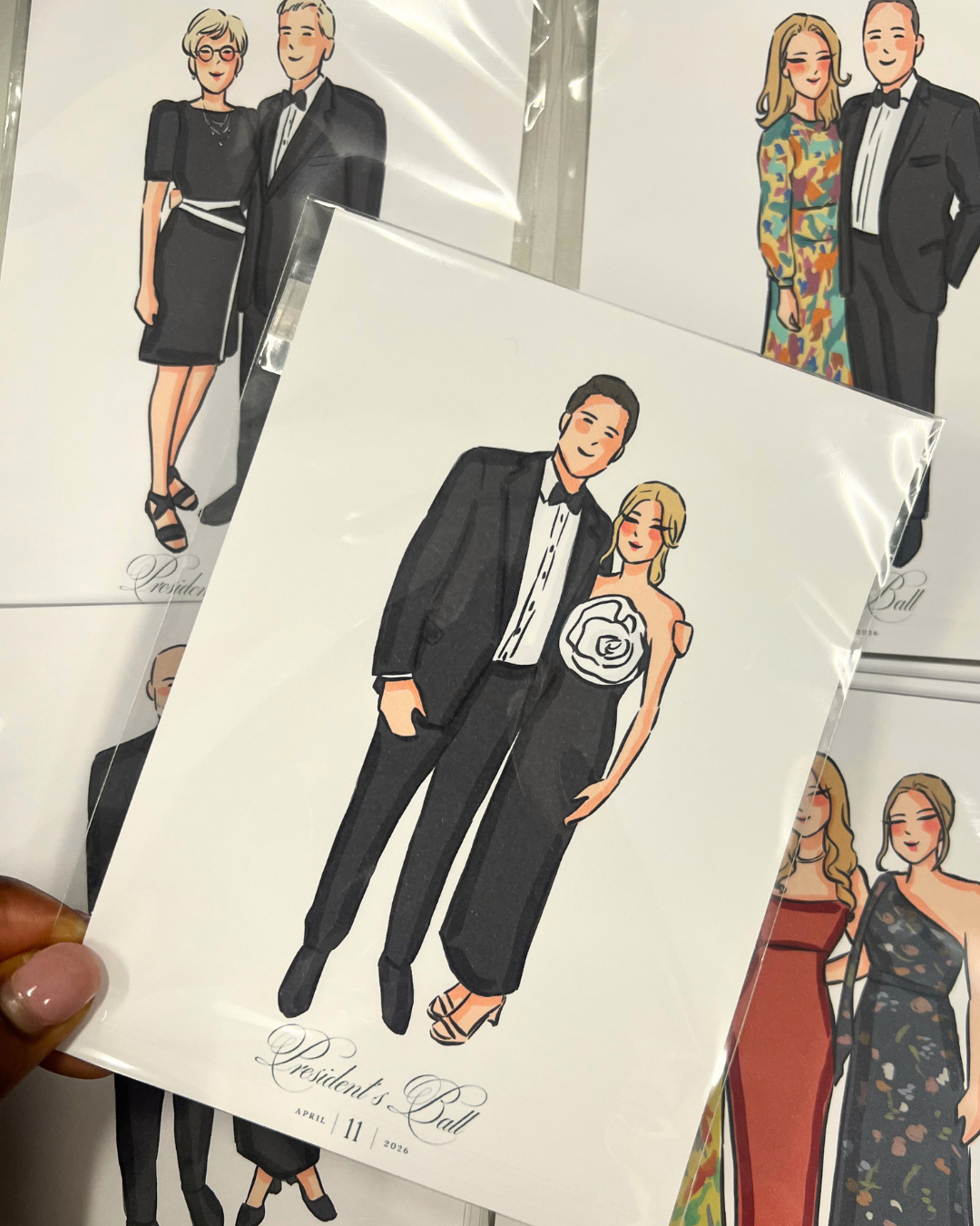 Custom fashion sketches created by a wedding guest illustrator at a formal event.
