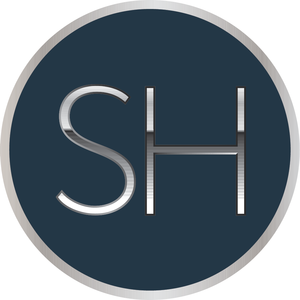 Close-up of a dark blue circular logo with the silver letters 'SH' in the center.
