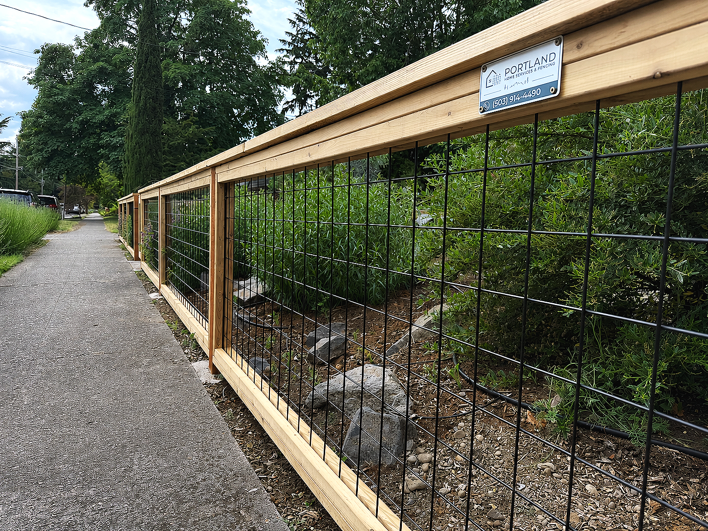 Cedar-framed hog wire fence with cedar top cap installed by Portland Home Services & Fencing in Northeast Portland.