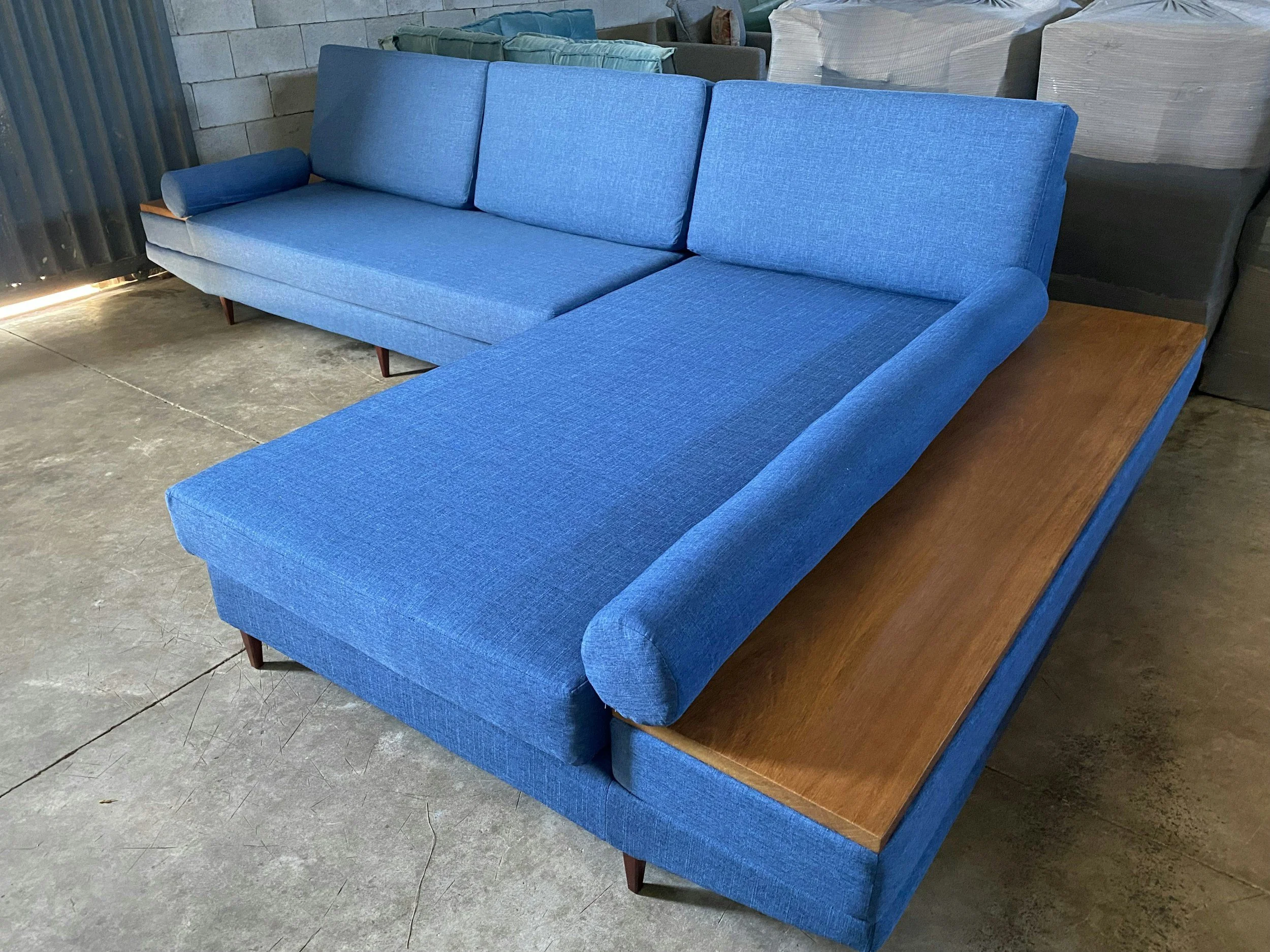 Vibrant blue sectional on a cool industrial concrete floor