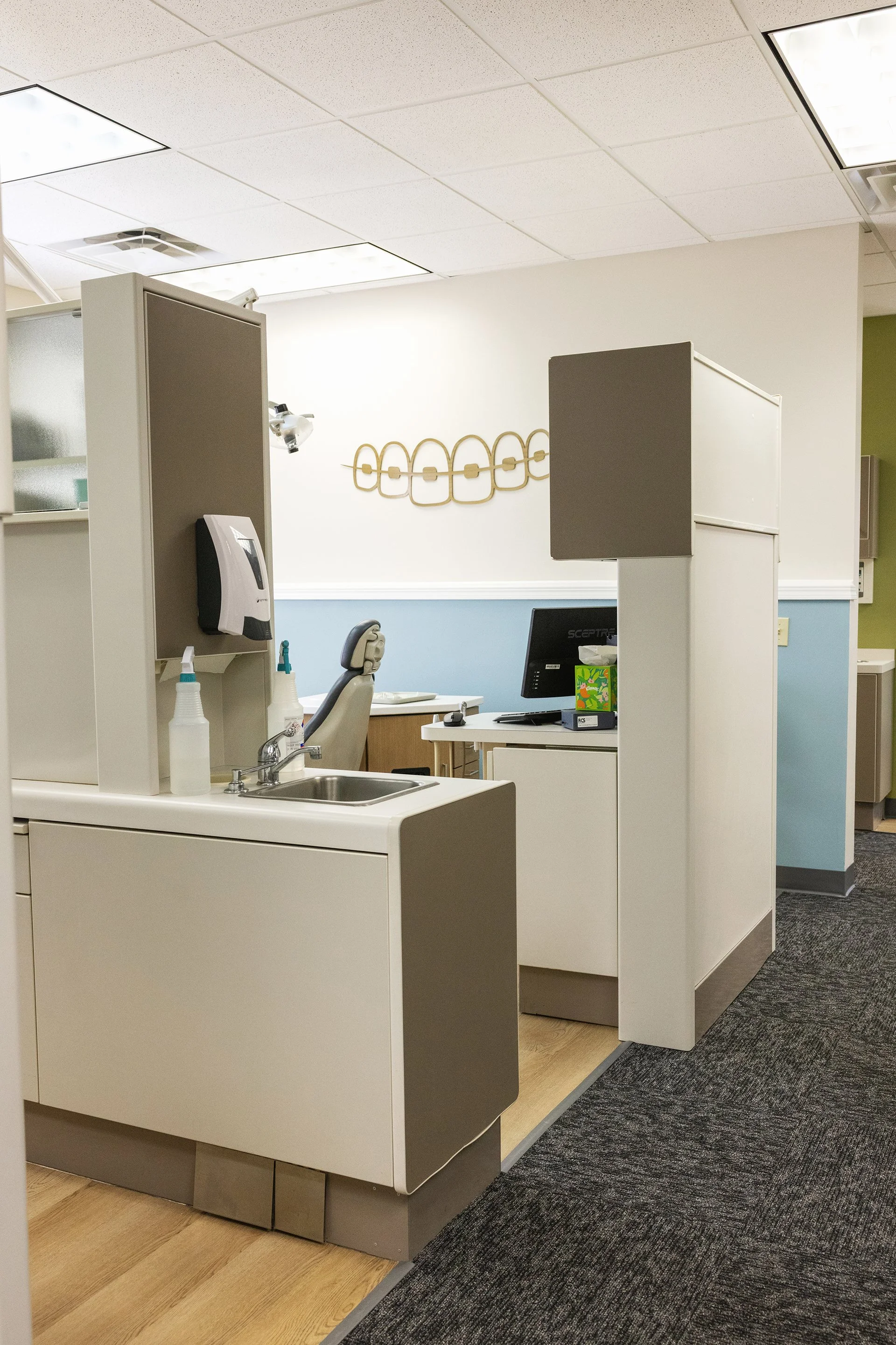 Patient treatment room at Sander Orthodontic Arts in Andover, KS, featuring a decorative braces-inspired wall art piece