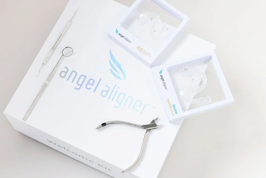 Angel Aligner clear aligners held by a patient at Sander Orthodontic Arts, Andover, KS.