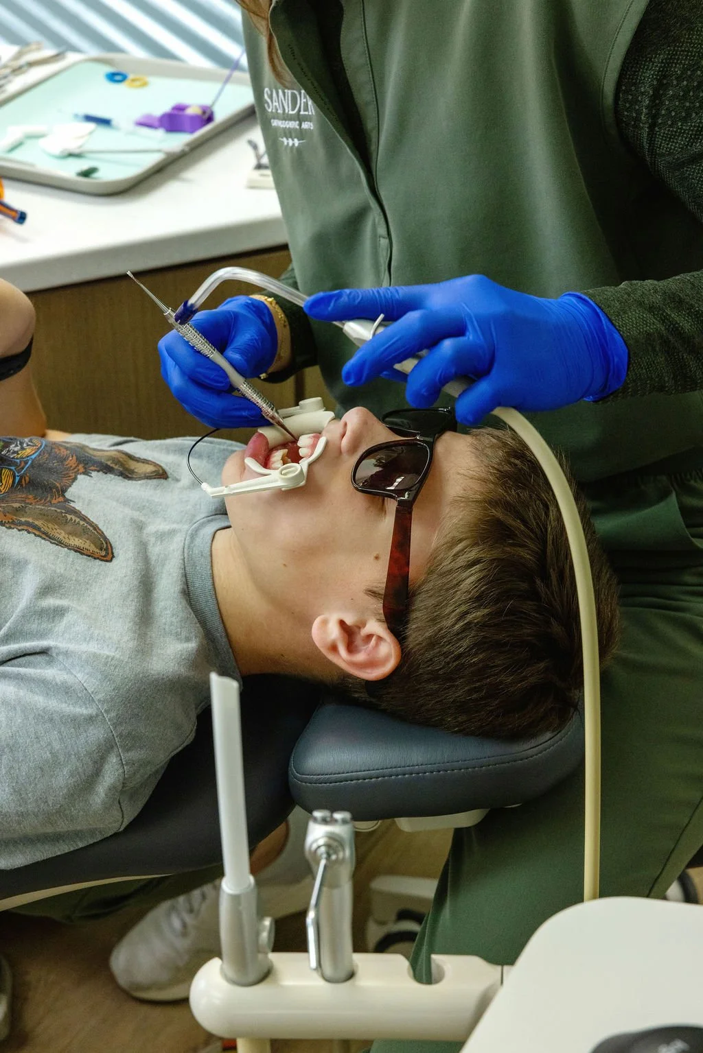 Child receiving orthodontic treatment with specialized tools, highlighting the advanced technology and expertise behind braces costs
