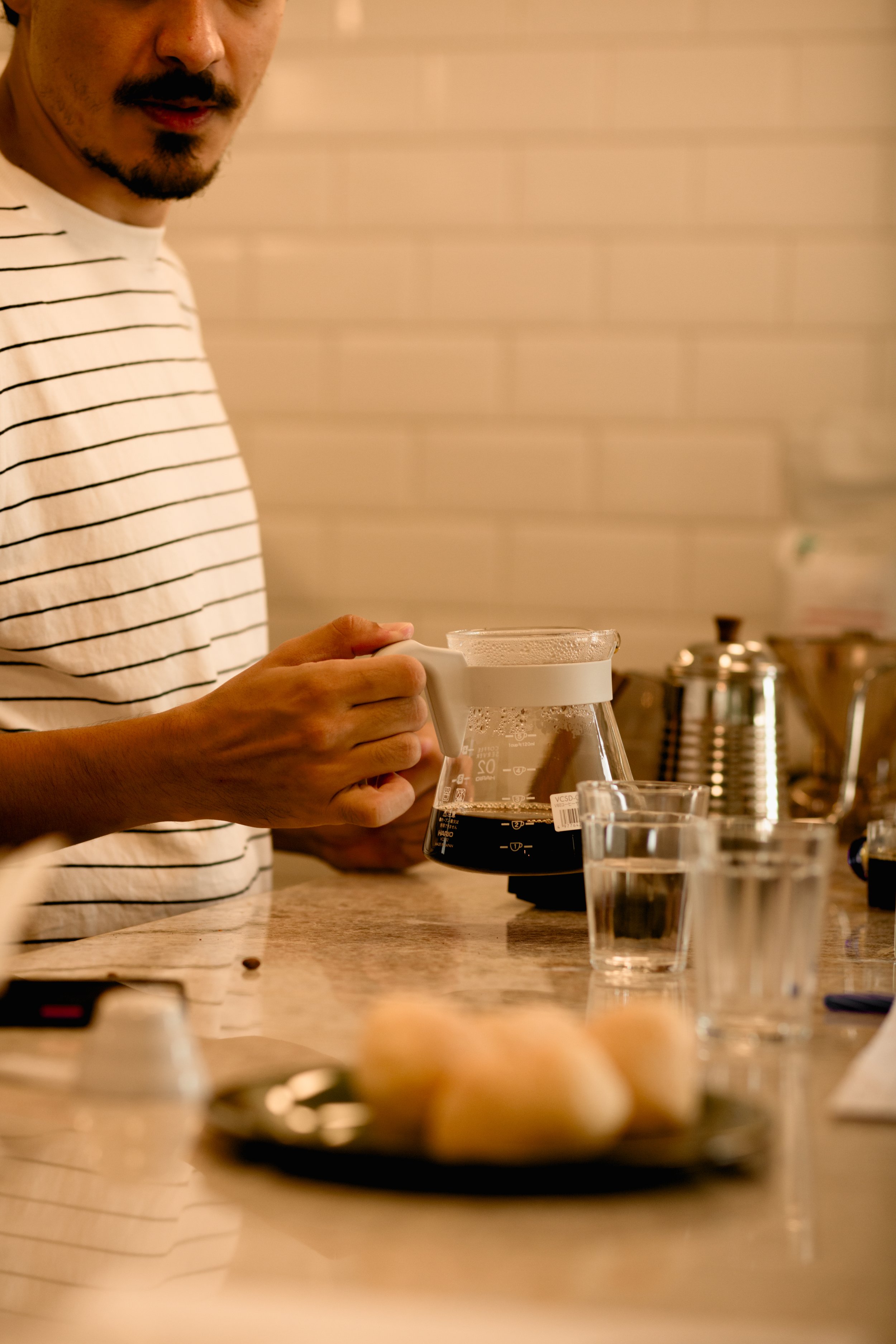 barista serving filter coffee