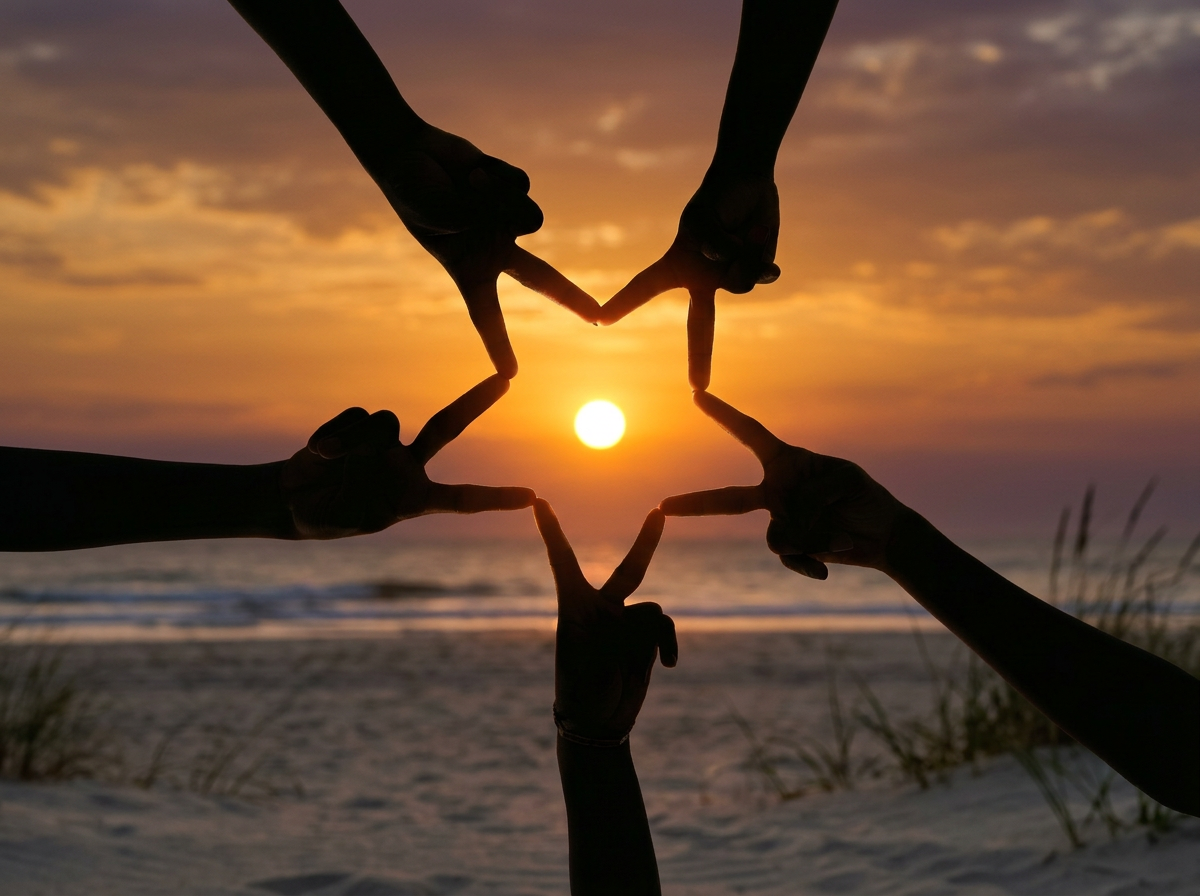 Image in silhouette of hands creating a star