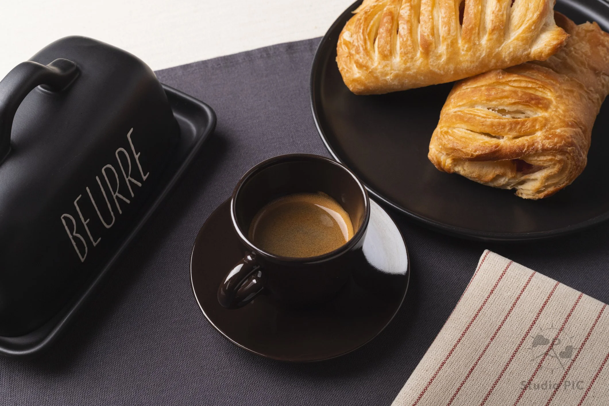 Photo d'un bon café Espresso fraîchement coulé ainsi qu'une pâtisserie prête à être dégustée.