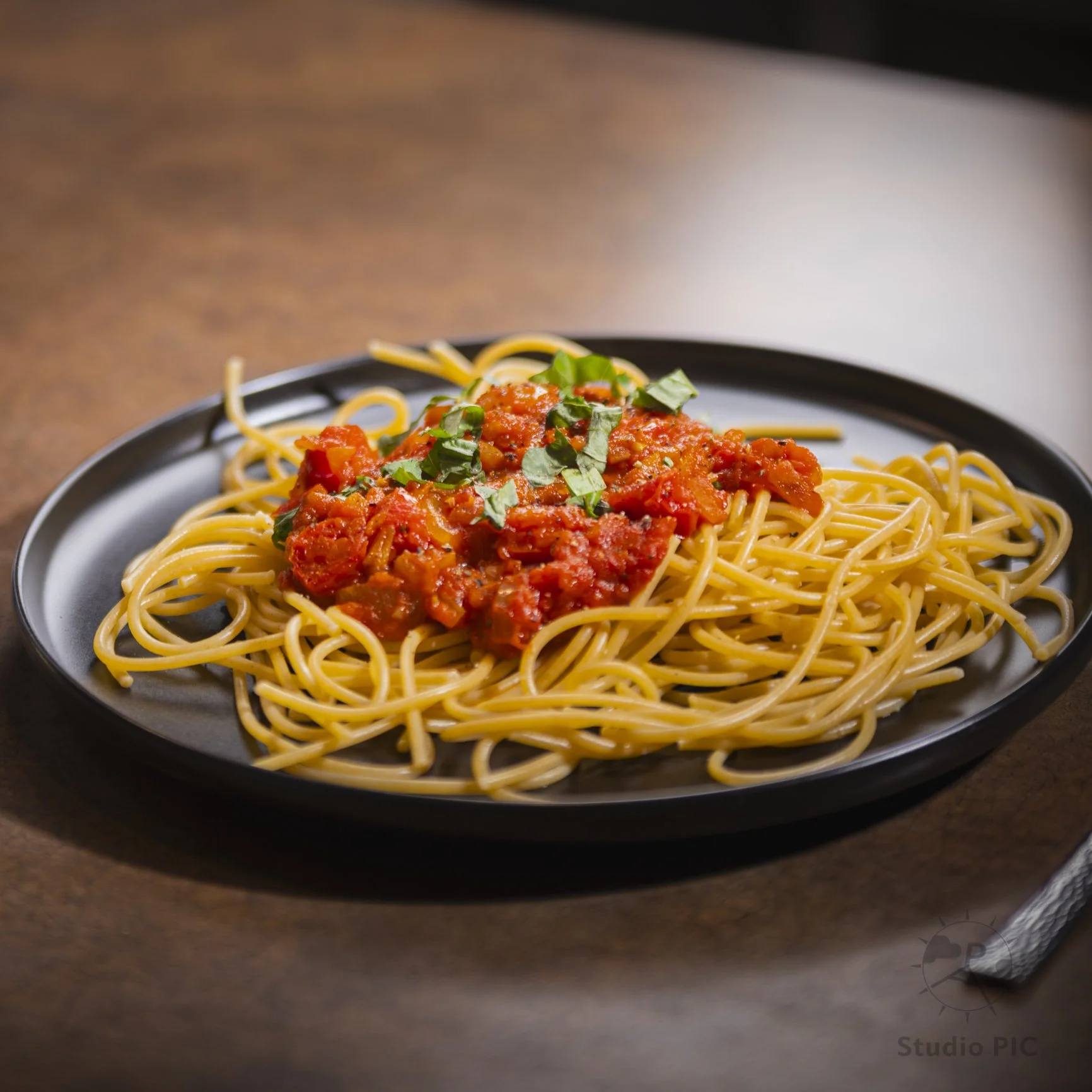 Photo d'une assiette digne d'un restaurant. Un délicieux plats de pâtes pris en photo en lumière contrôlée en studio.