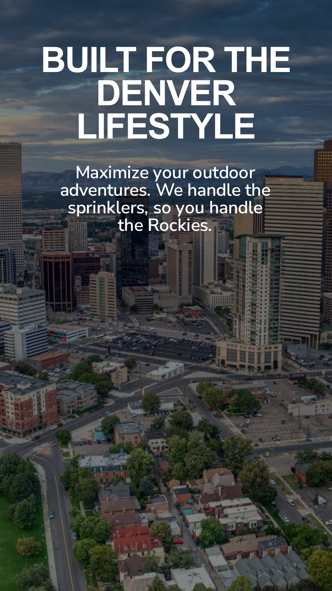 Aerial view of Denver city skyline during daytime with skyscrapers, office buildings, and residential area, under a partly cloudy sky.