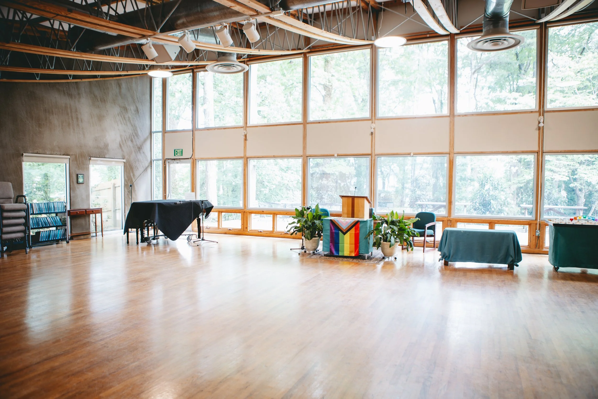washed in light from a wall of windows, the wooden floors of a wide open sanctuary gleam