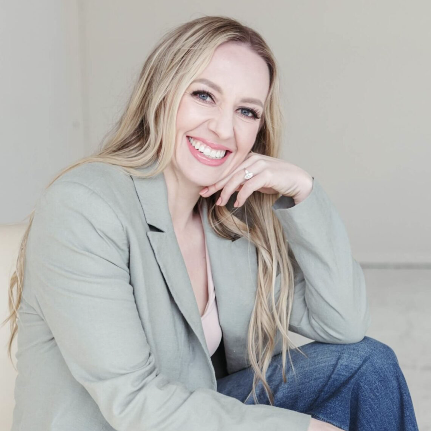 Jillian, a certified money coach for entrepreneurs, smiles at the camera