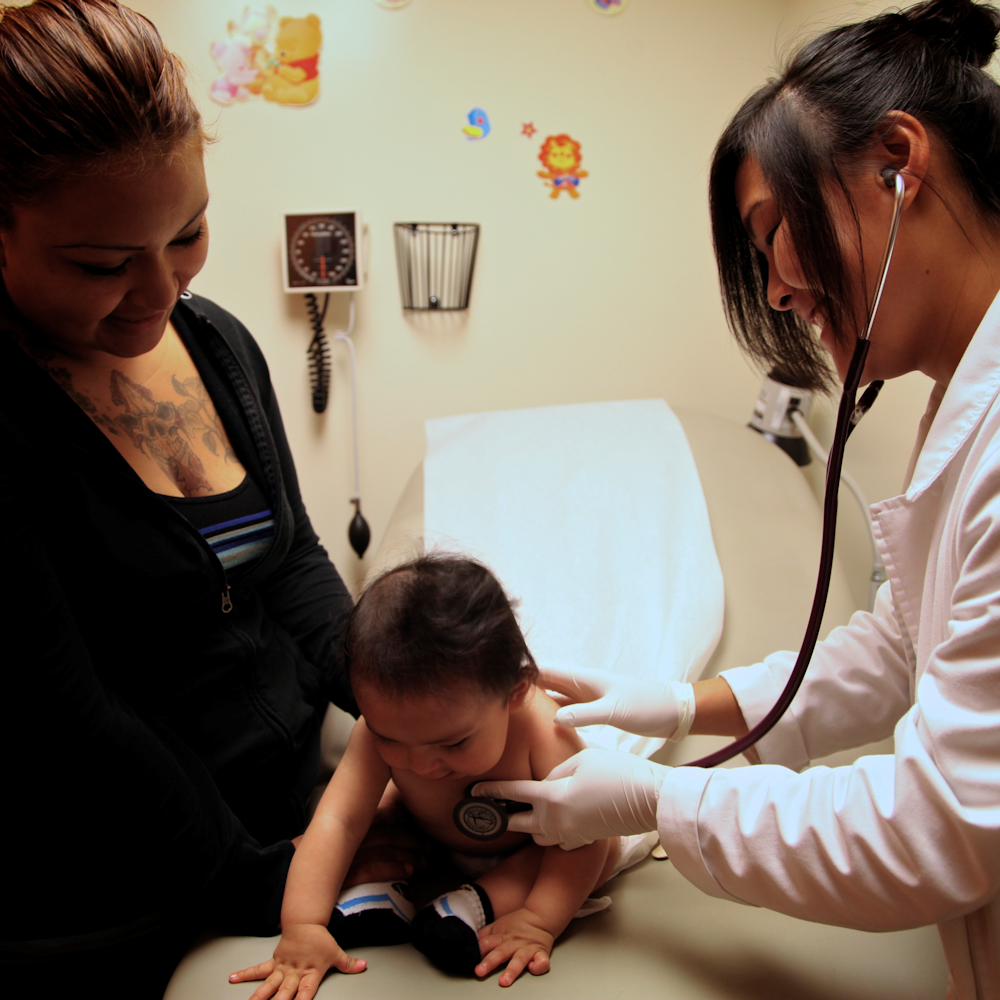 pediatric doctor checking baby.png