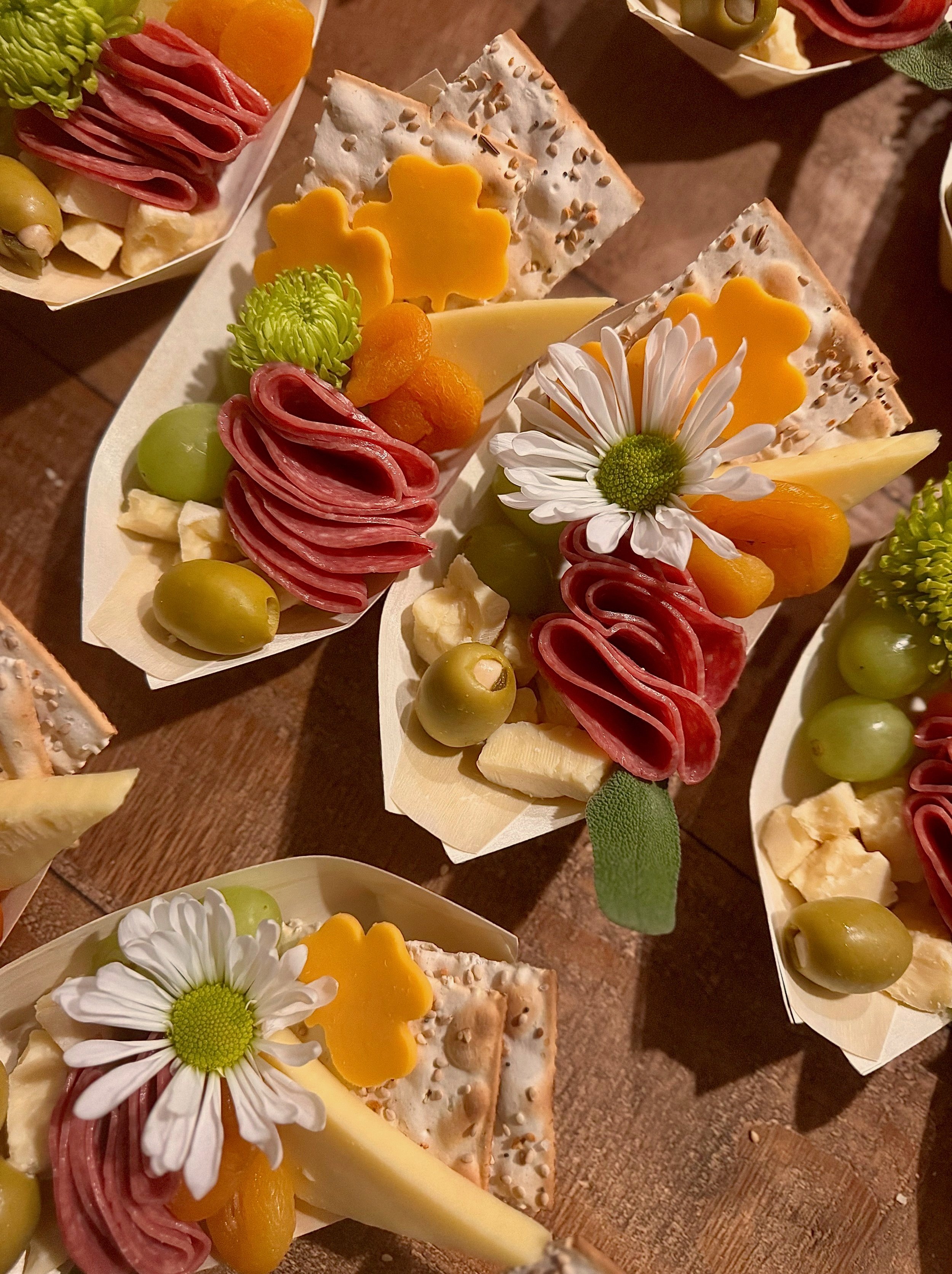 Assorted fresh fruit and cheese platter with strawberries, blueberries, grapes, and sliced cheese.