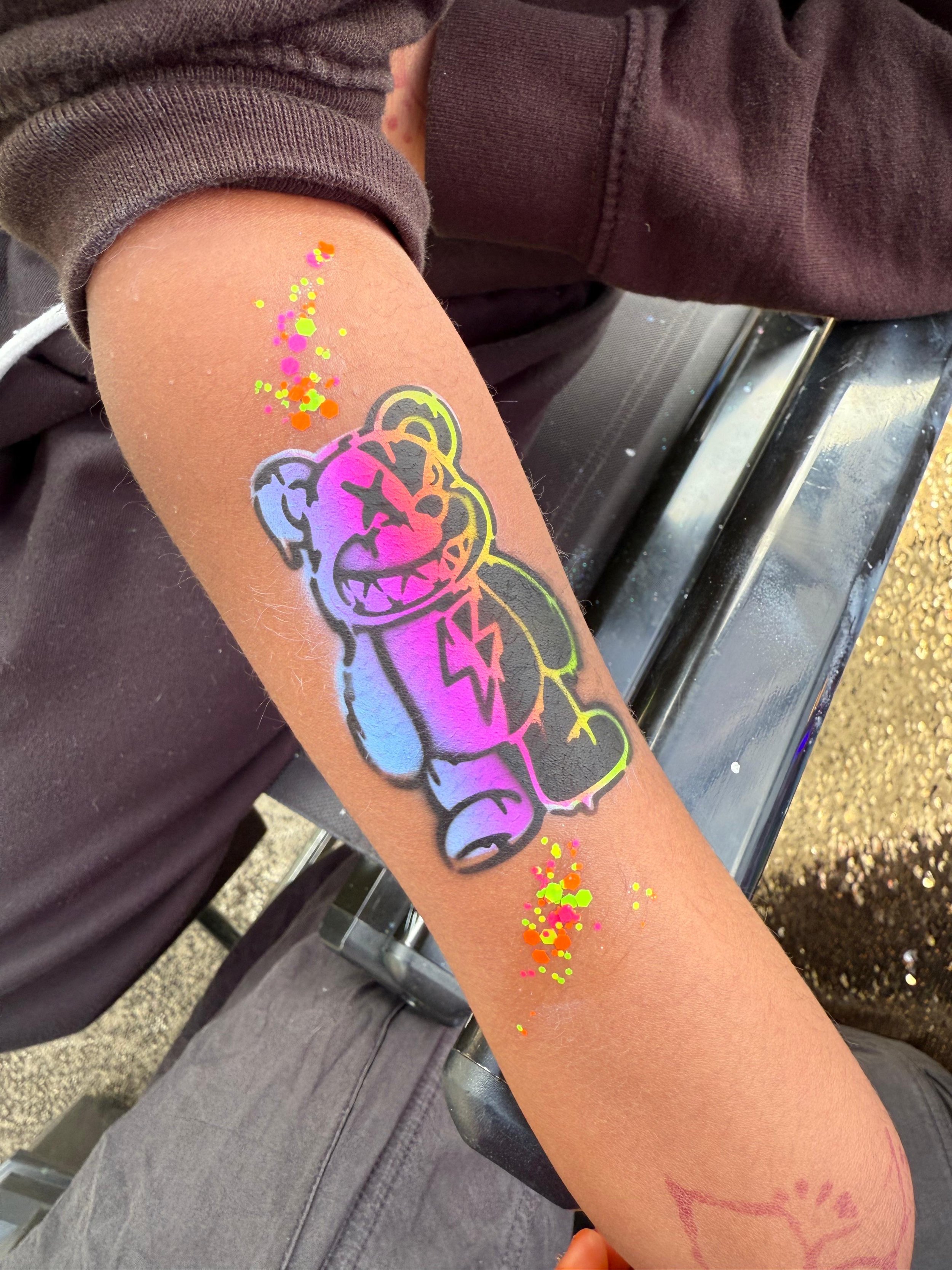 Airbrush tattoo fun for guests of all ages at a party