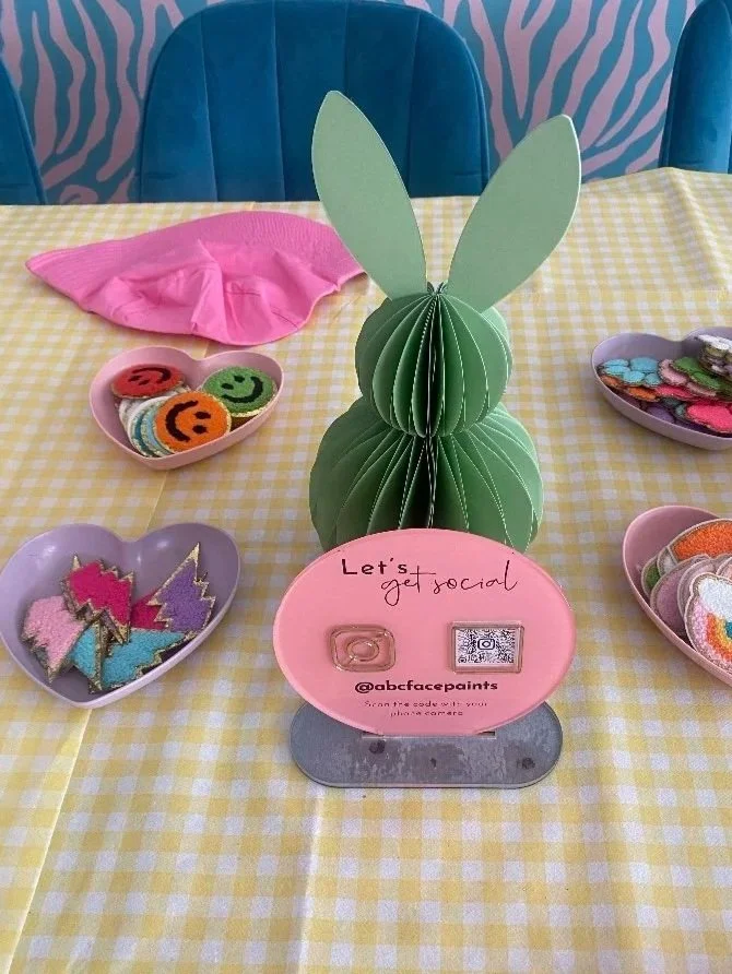Craft table setup with vibrant materials for kids at a company event