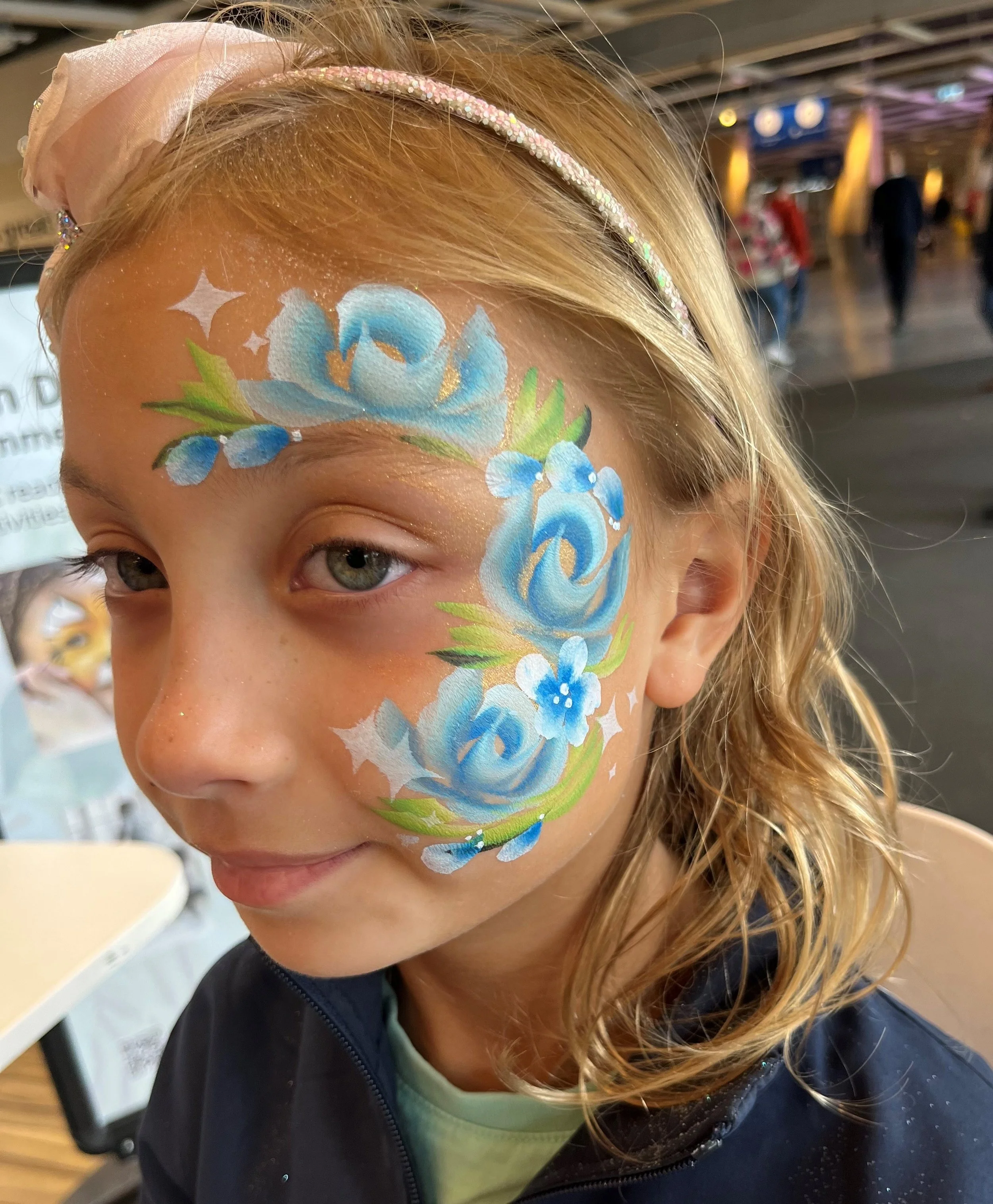 Professional face painter entertaining children at an event in Hammersmith and Fulham