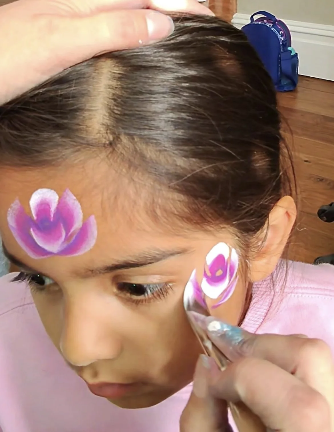 Children’s entertainment Wandsworth – kids enjoying glitter face paint and bubble braids at a school fair.