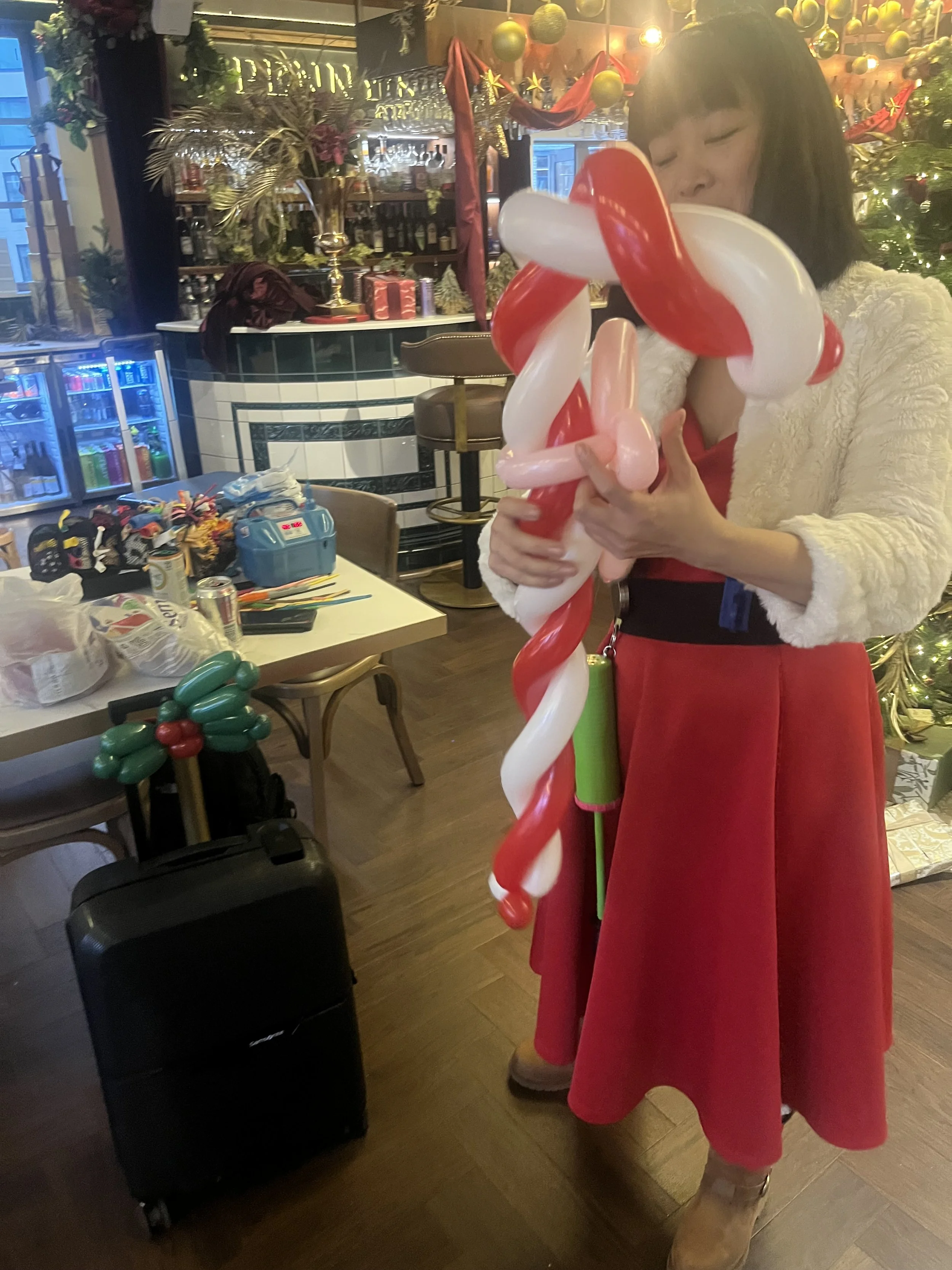 “Professional balloon modeller performing in the City of London”