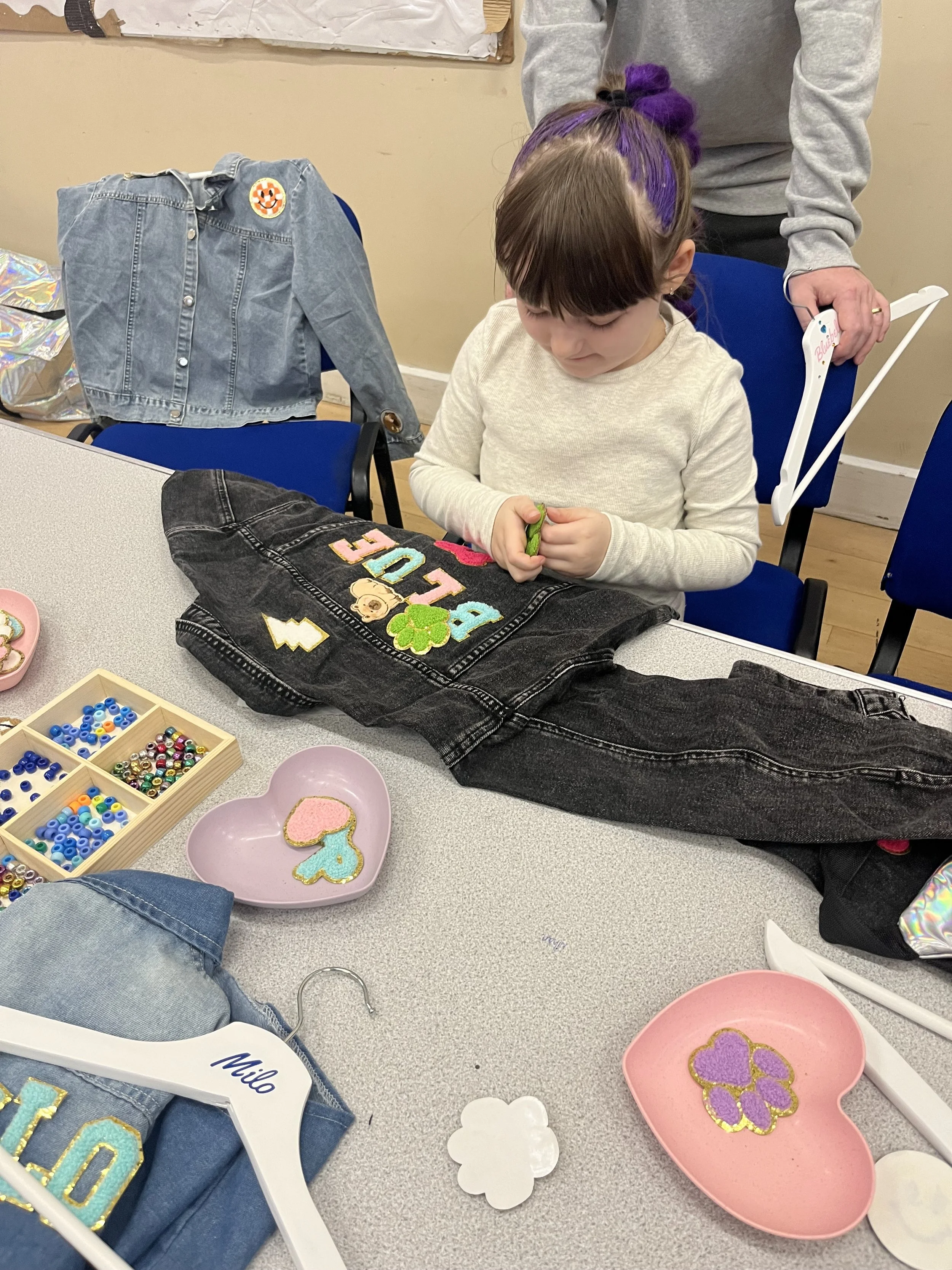 alt="Kids enjoying a patch party with denim jacket personalisation"