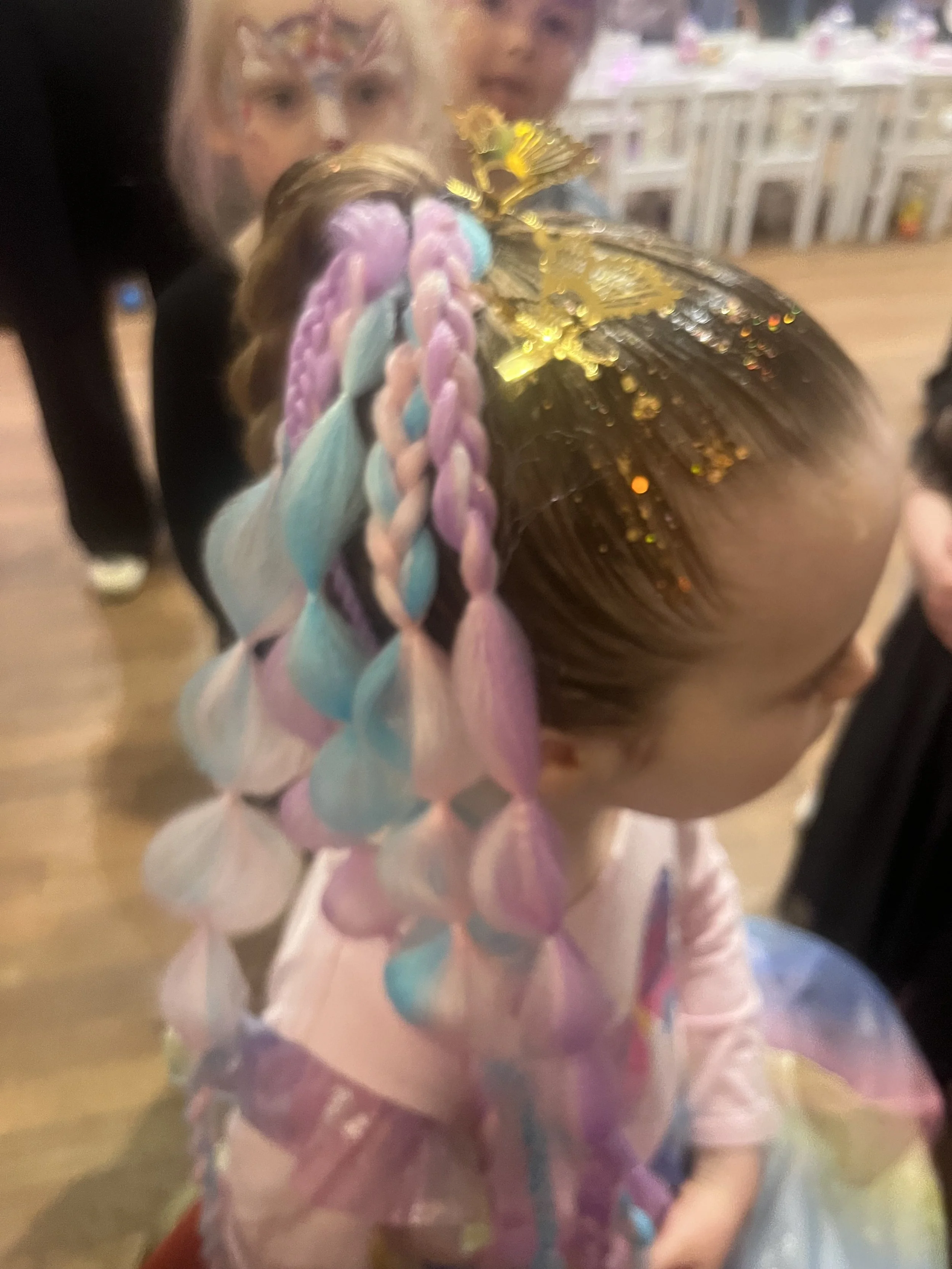"Hair stylist creating fun children’s party hairstyles in St James’s, London."
