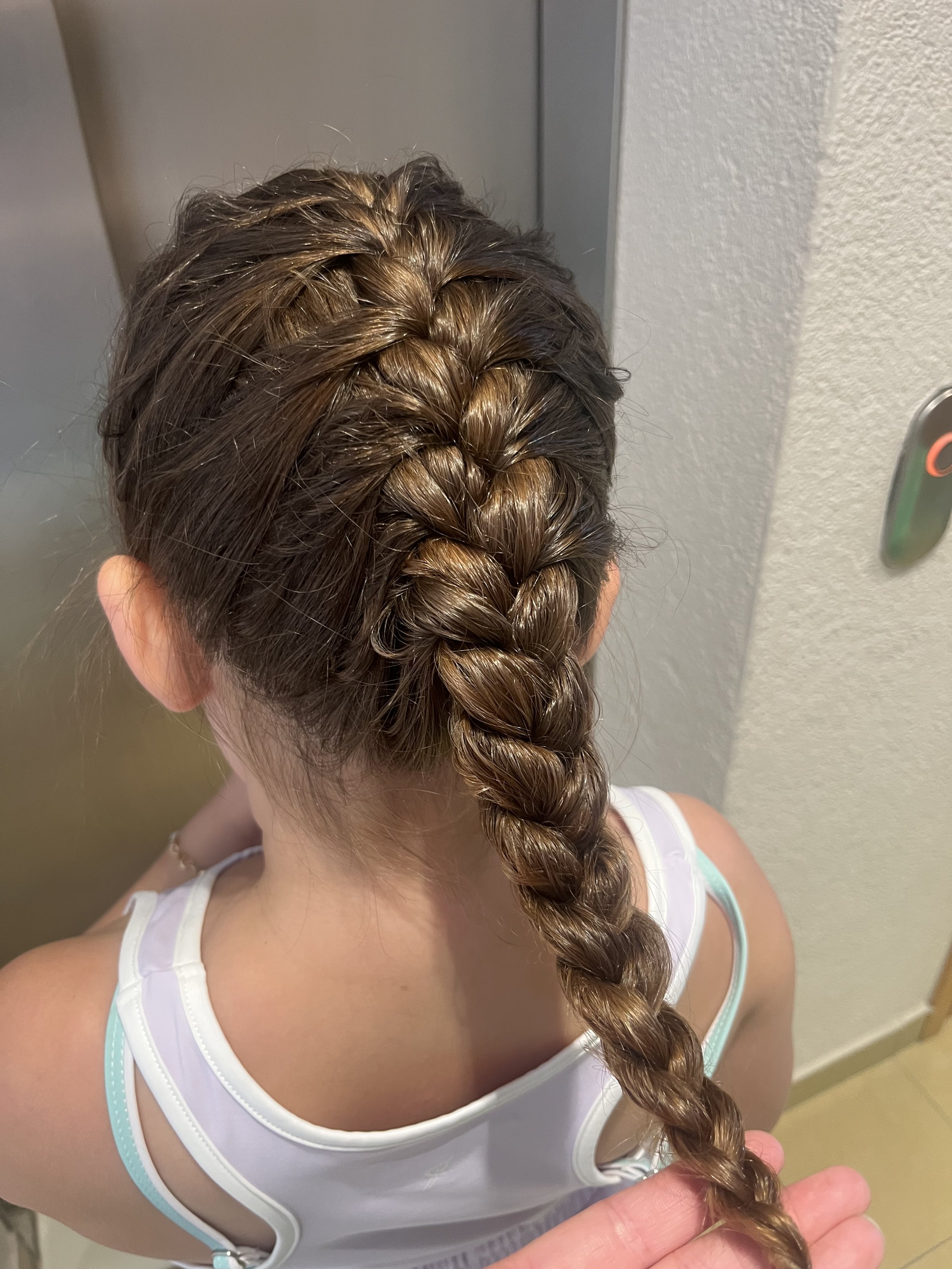 "Hair braiding entertainment at a school event in South West London"