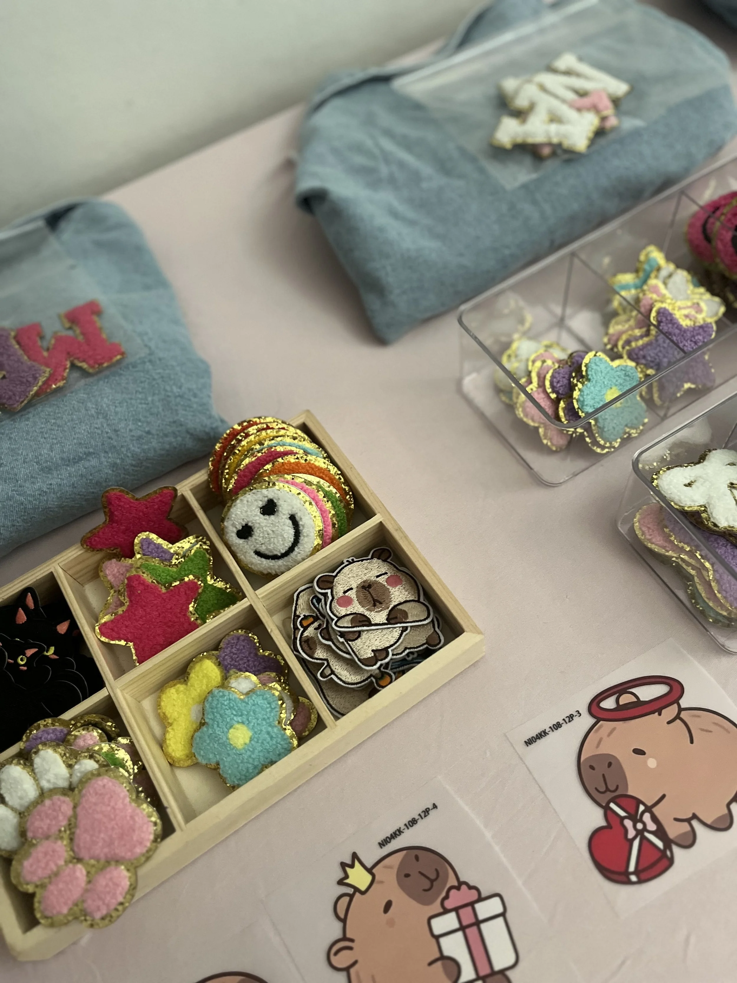 alt="Children decorating denim jackets at a craft party in London"