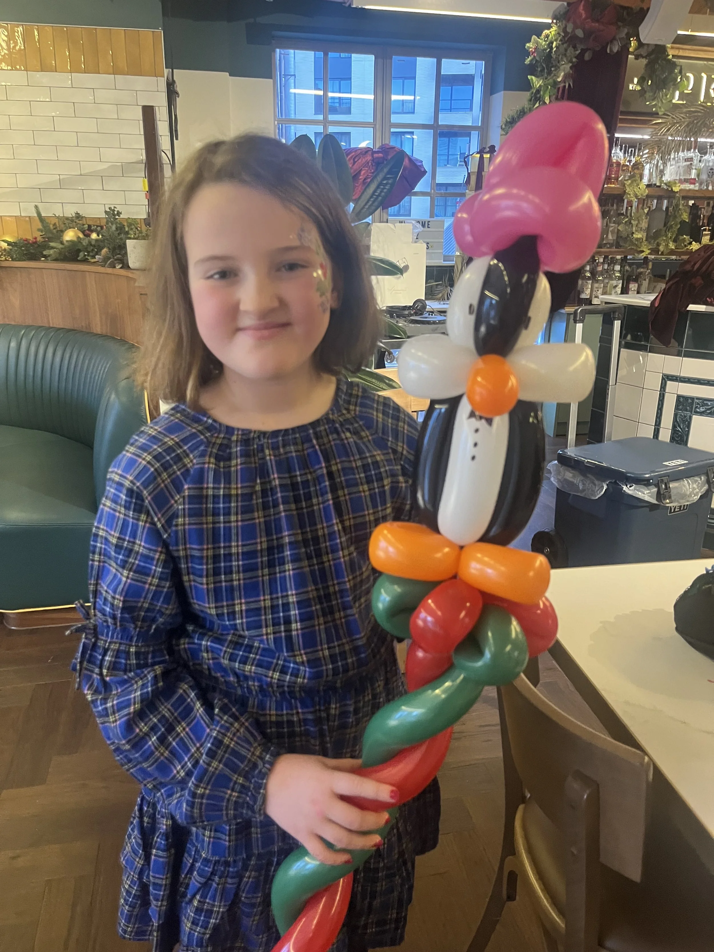 “Children’s balloon twisting entertainer at a party in South London”