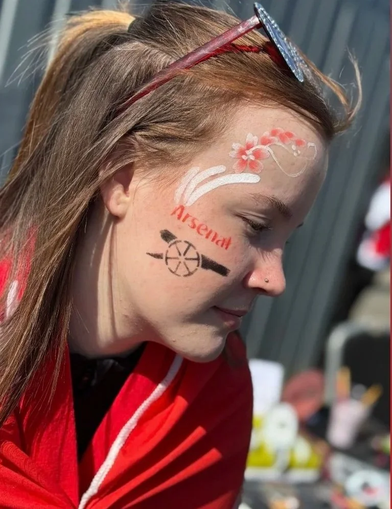 “Professional face painter creating colourful designs for children’s parties in South London.”