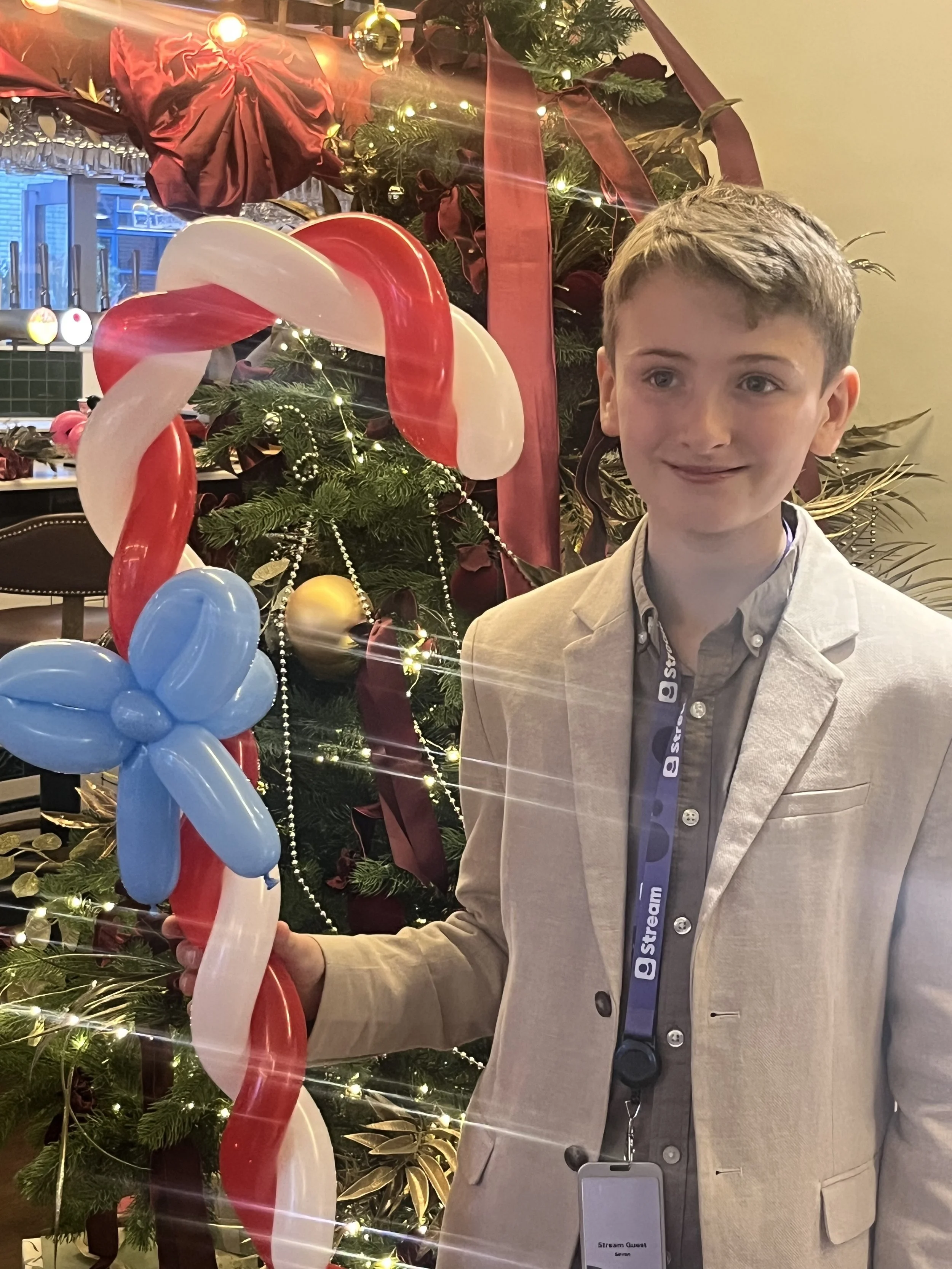 “Balloon modeller making custom balloon designs in South London”