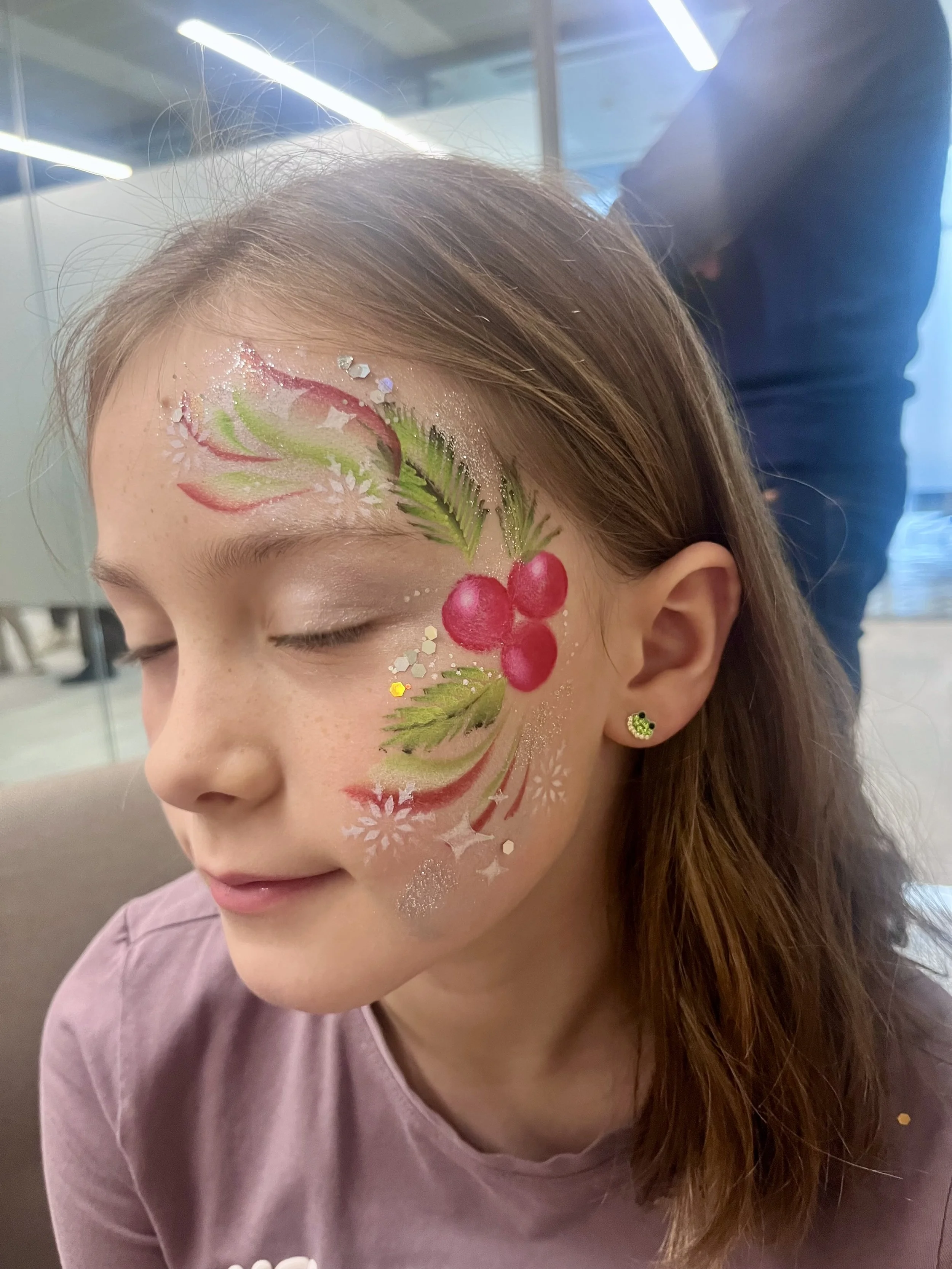 “Professional face painter creating colourful designs for children at a party in Sutton.”