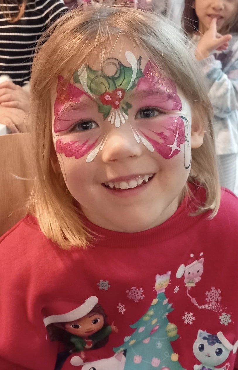 "Employee enjoying Christmas face painting at London corporate event"