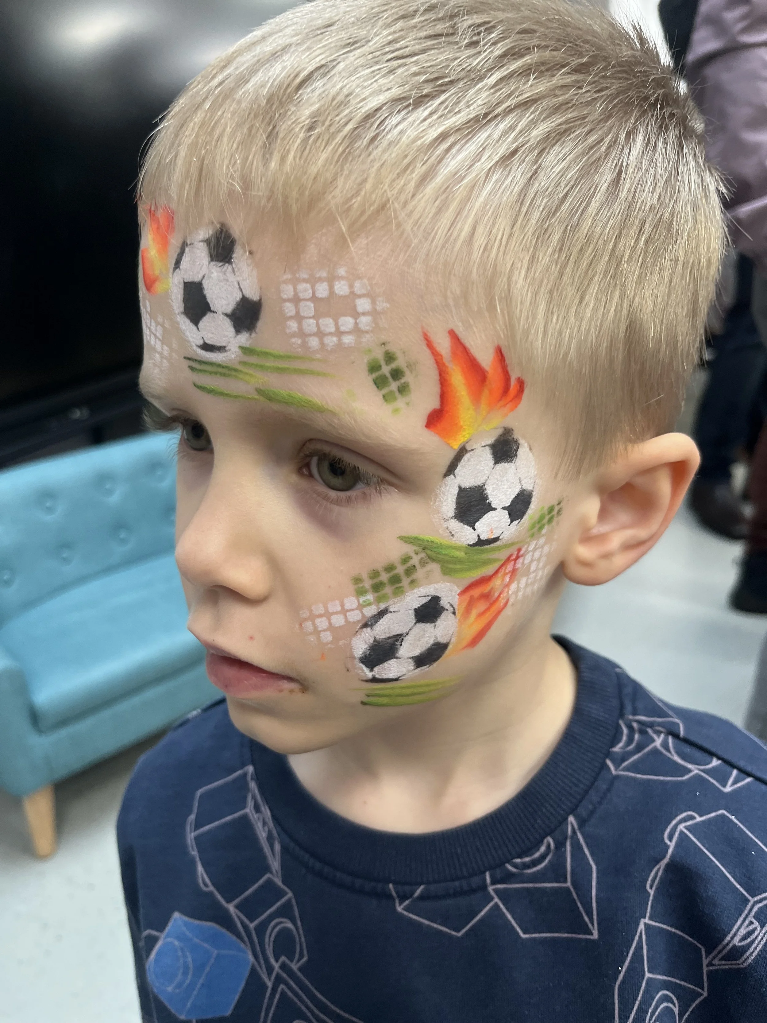 Professional children’s face painter creating colourful designs in London