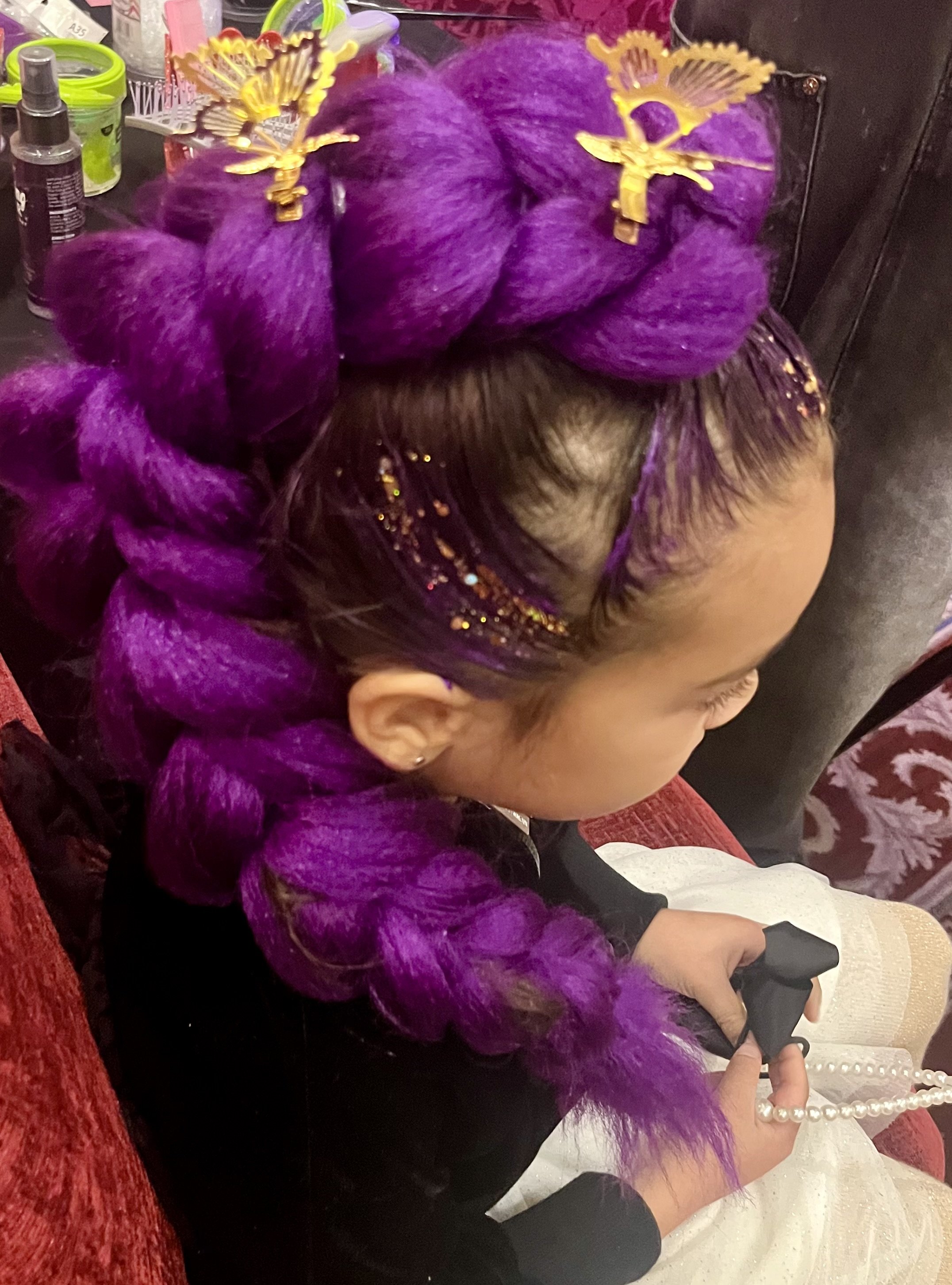 "Kids enjoying creative hair styling at South London community celebration"

