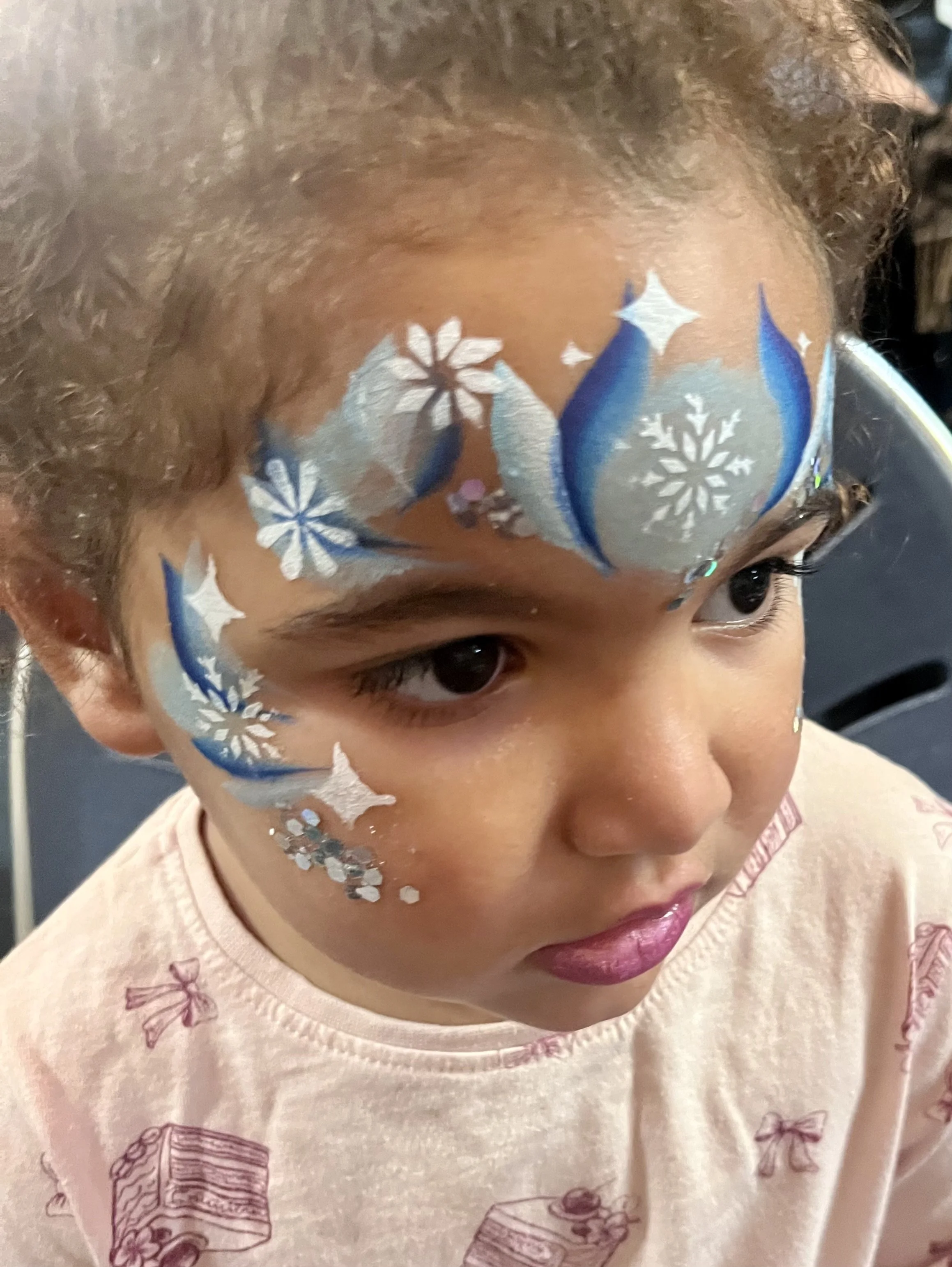 Professional face painter entertaining children at an event in Epsom