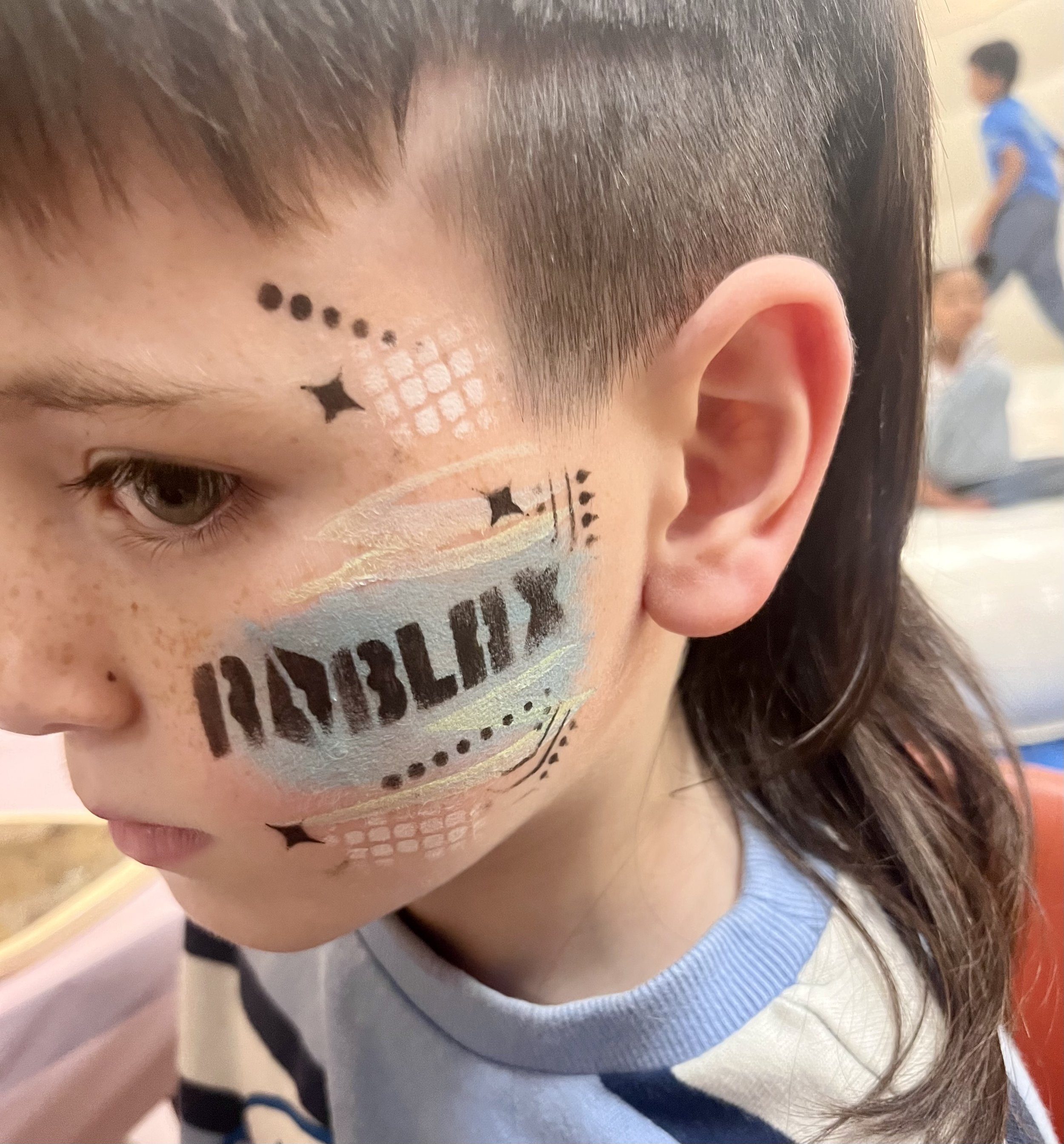 Creative face painting for children at a party in London