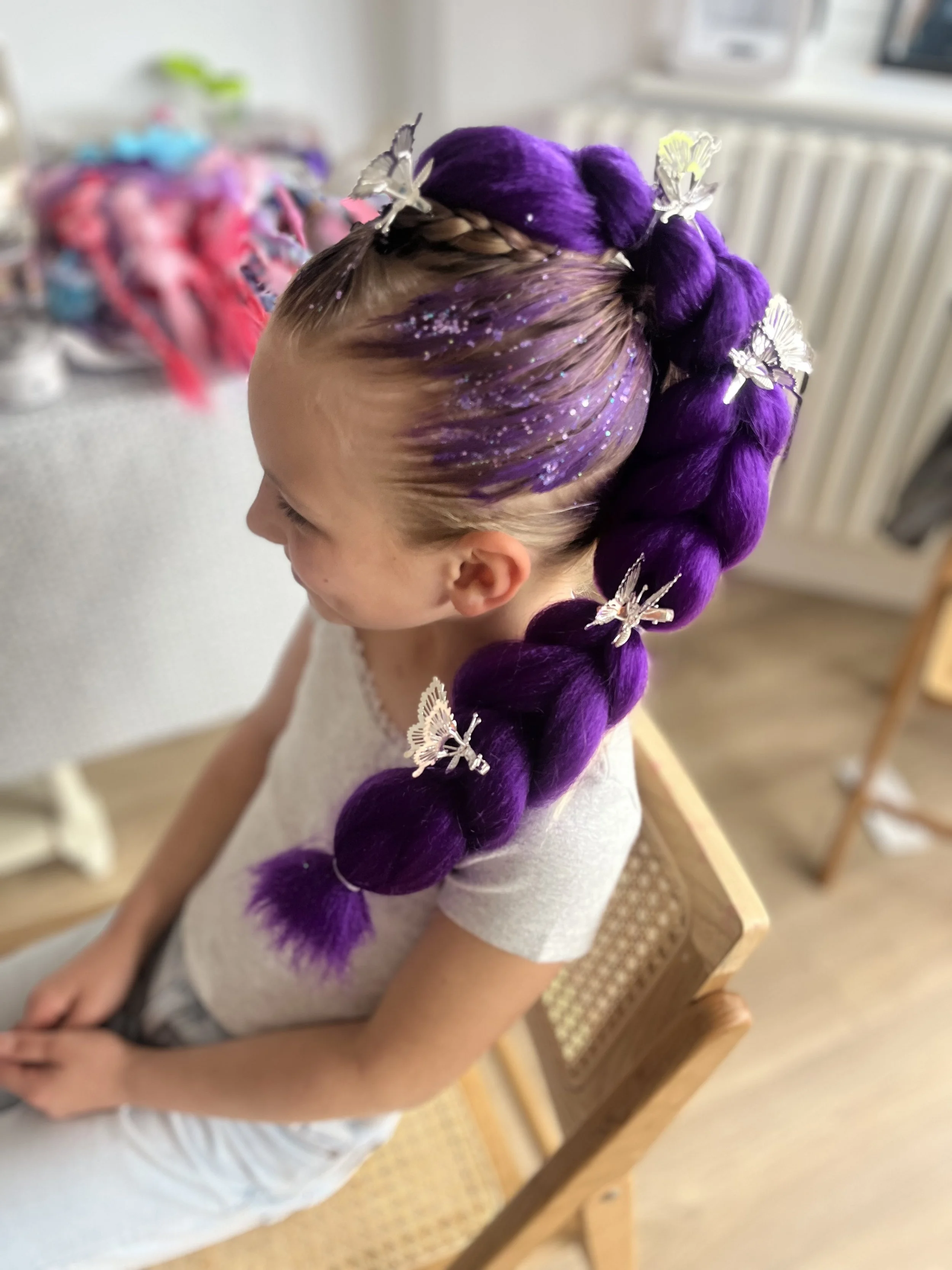 “Professional face painter creating colourful designs for children at a party in Sutton.”