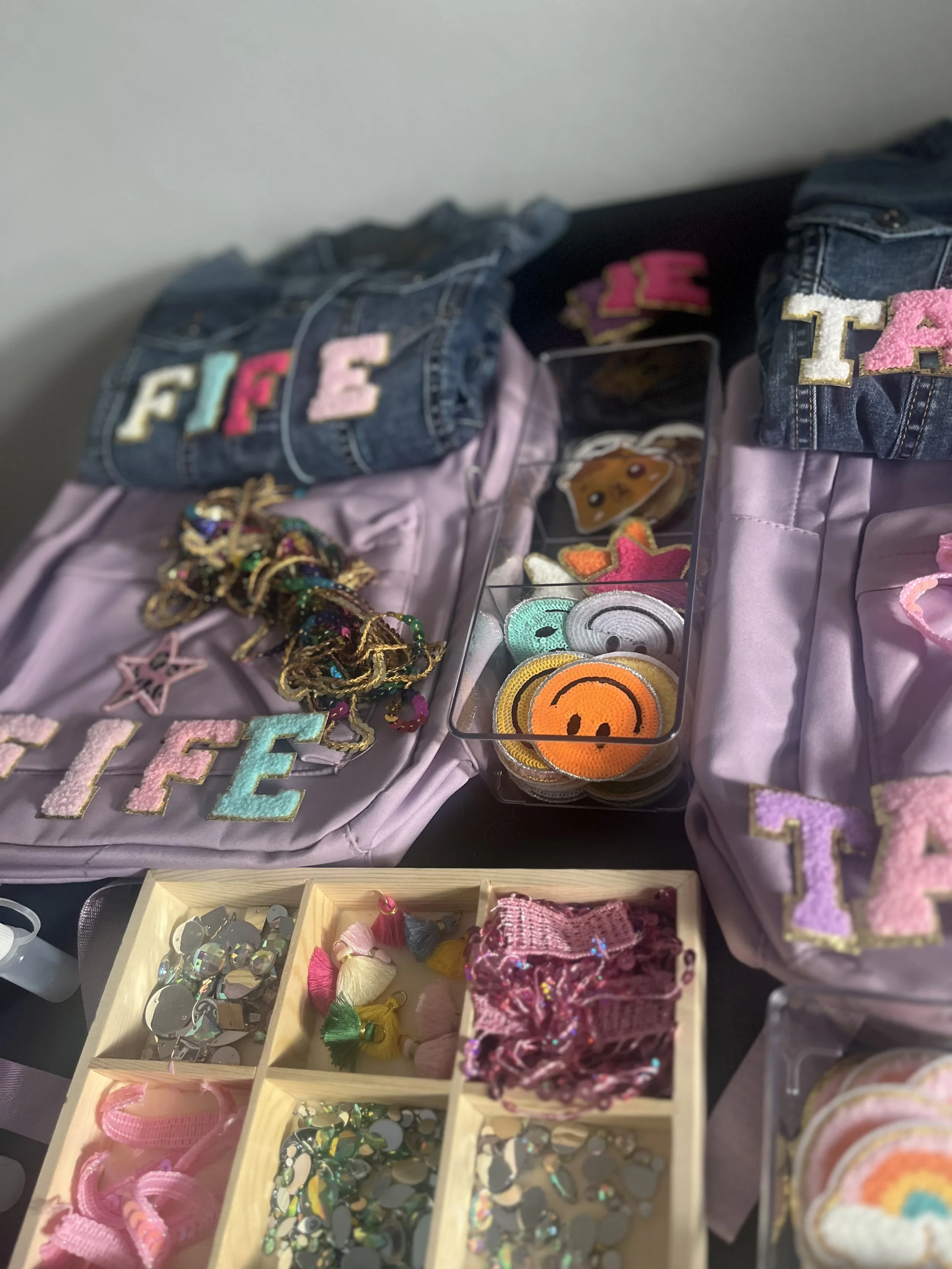 "Kids decorating rucksacks at a creative activity station"