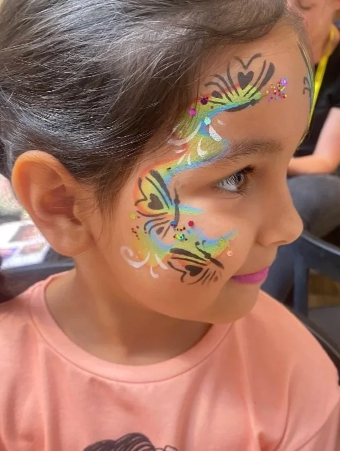 Children enjoying colourful face painting at a party in Lambeth